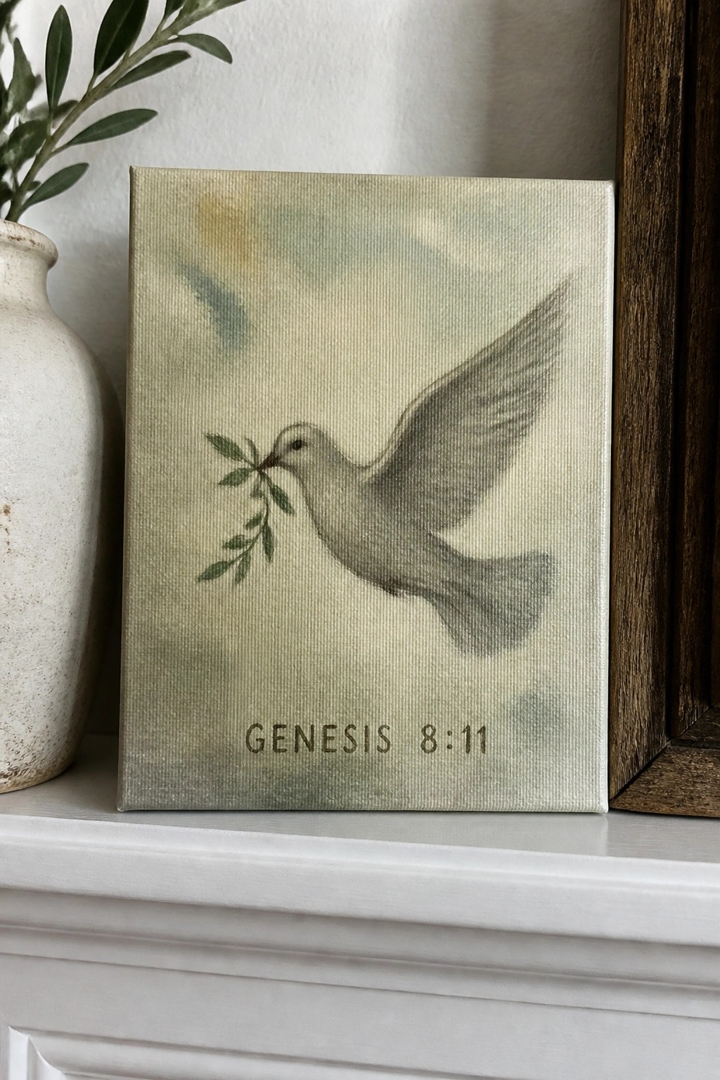 Canvas artwork of white dove carrying olive branch above Genesis 8:11 text on green background