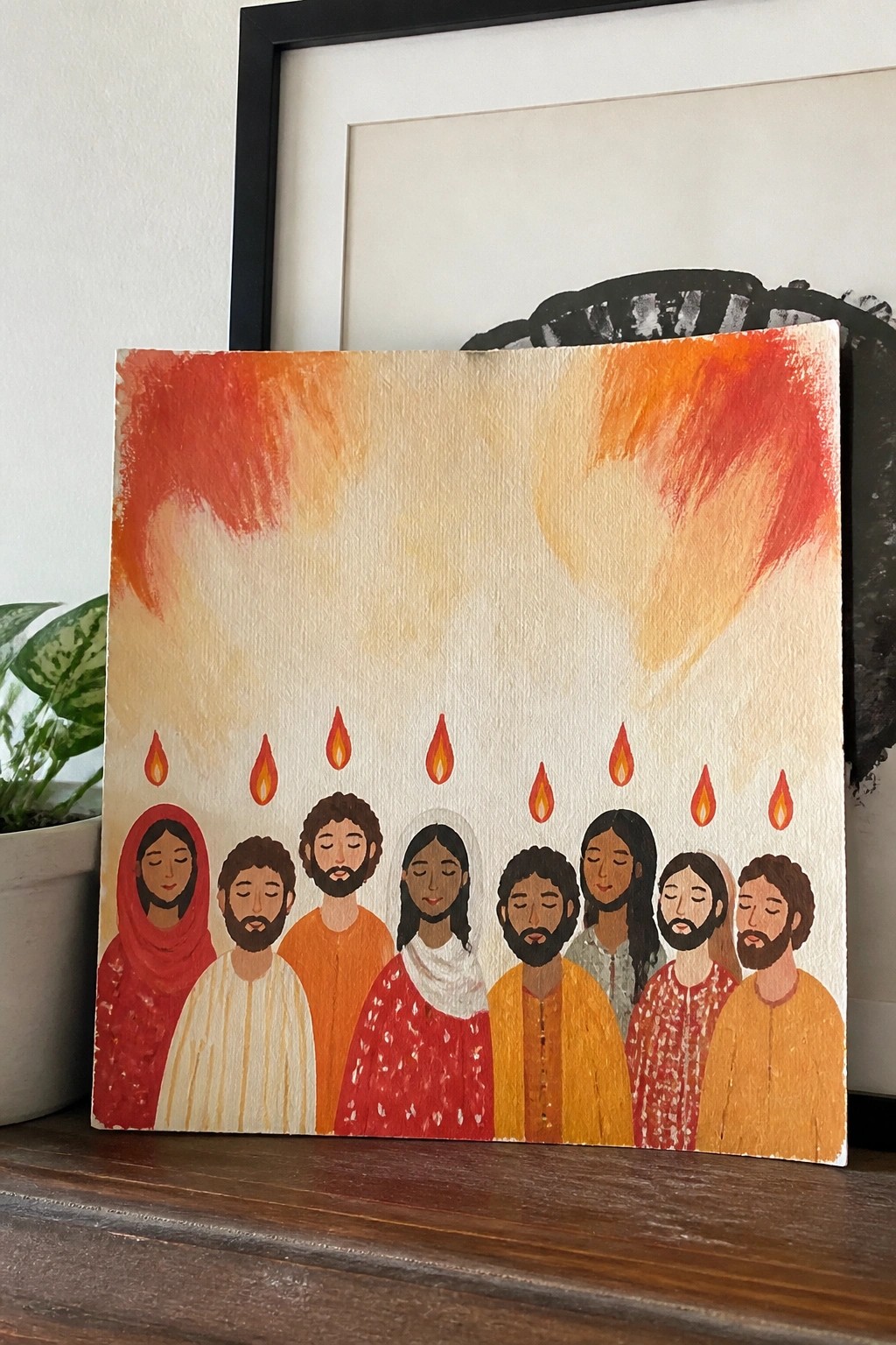 Naive painting of robed figures with flames above their heads on fiery background.