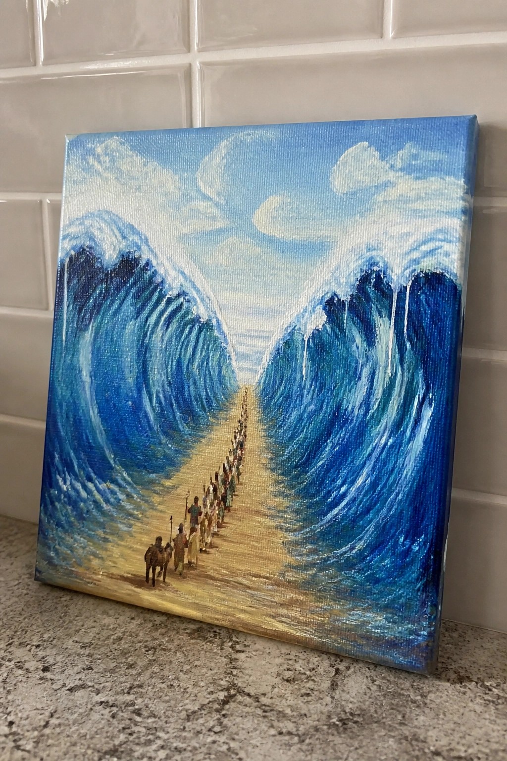 Canvas painting of robed figures walking between two towering blue waves on sand