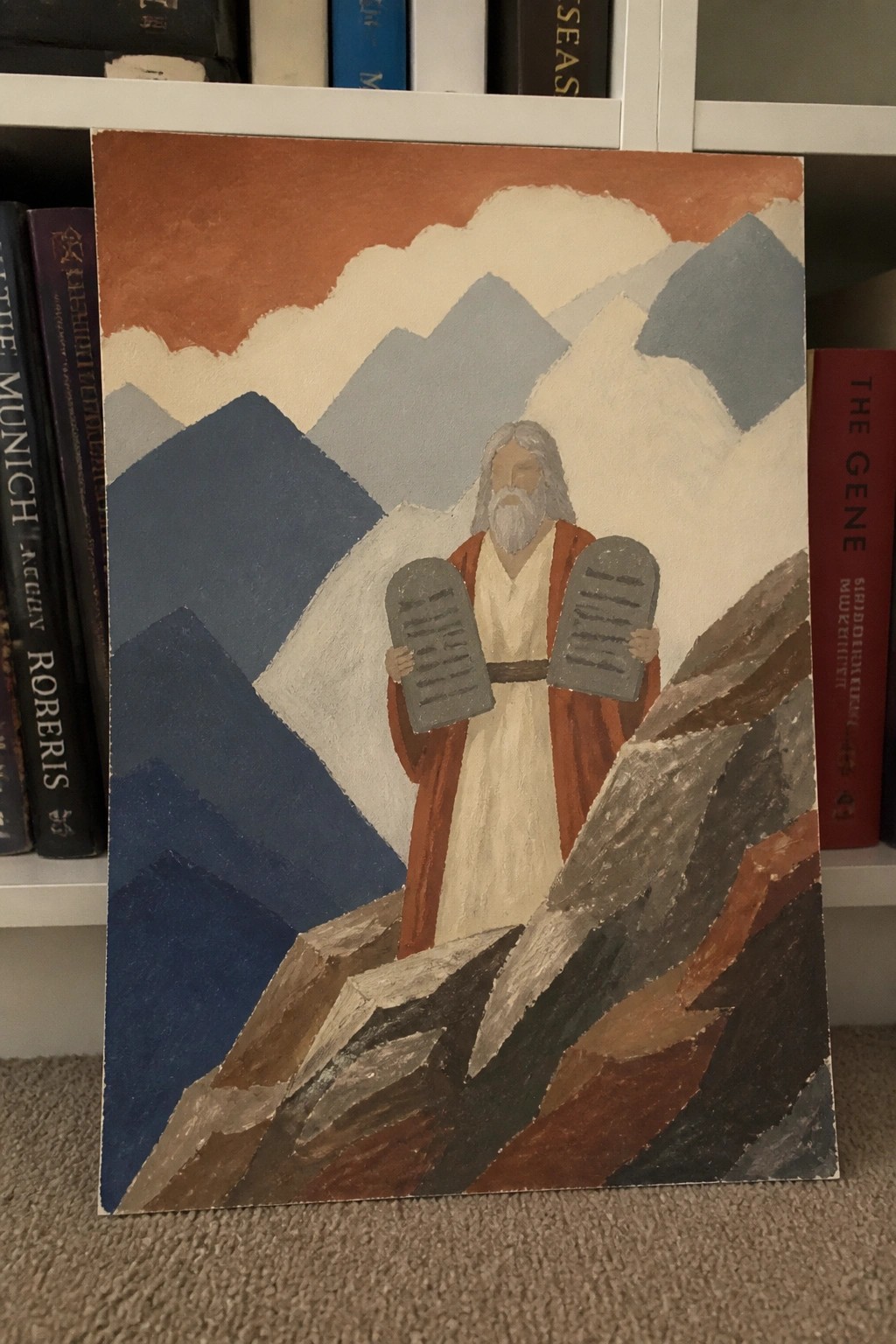 Bearded man in robes holding stone tablets on rocky peak with blue mountains and orange sky