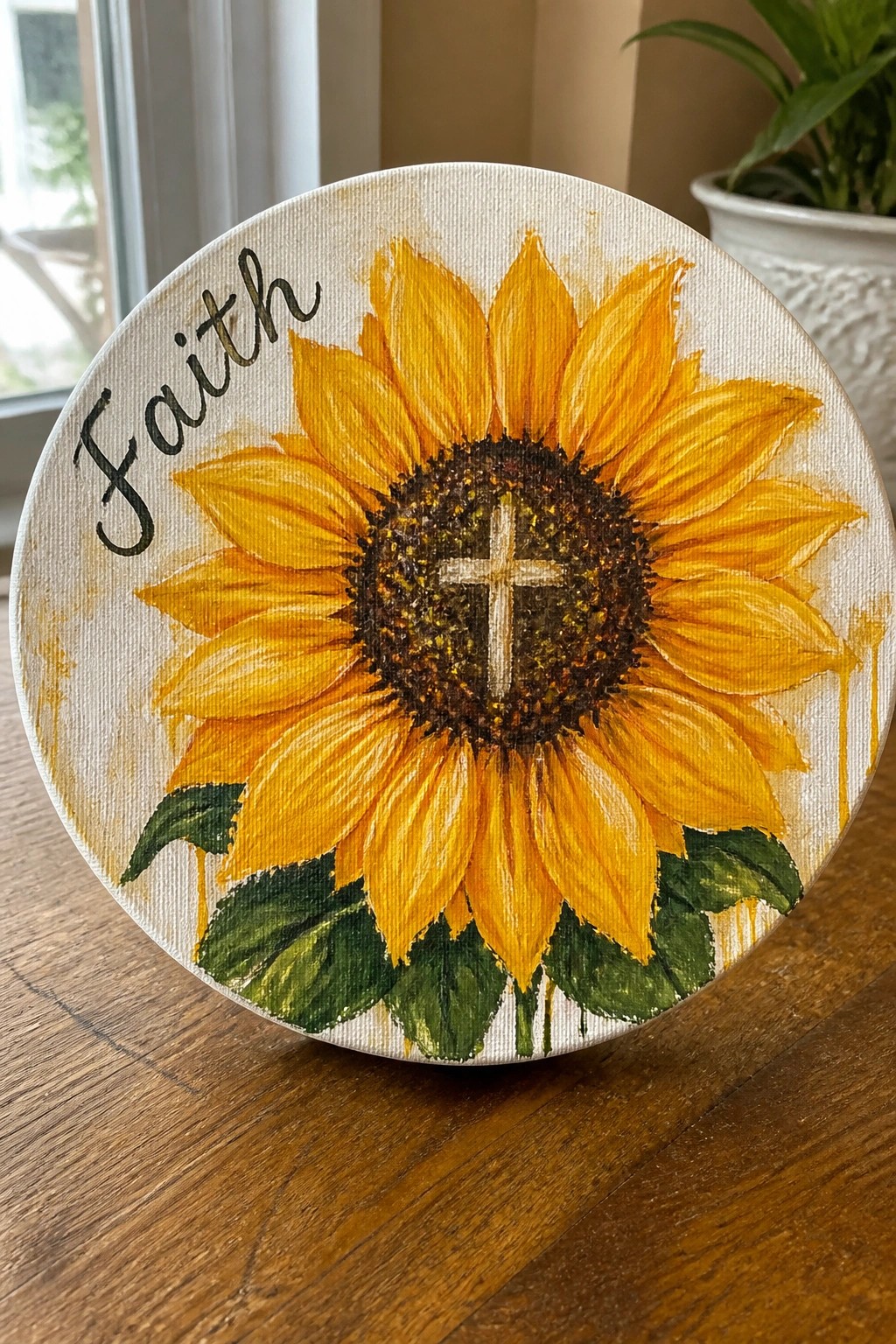 Round canvas with yellow sunflower, white cross in center, and 