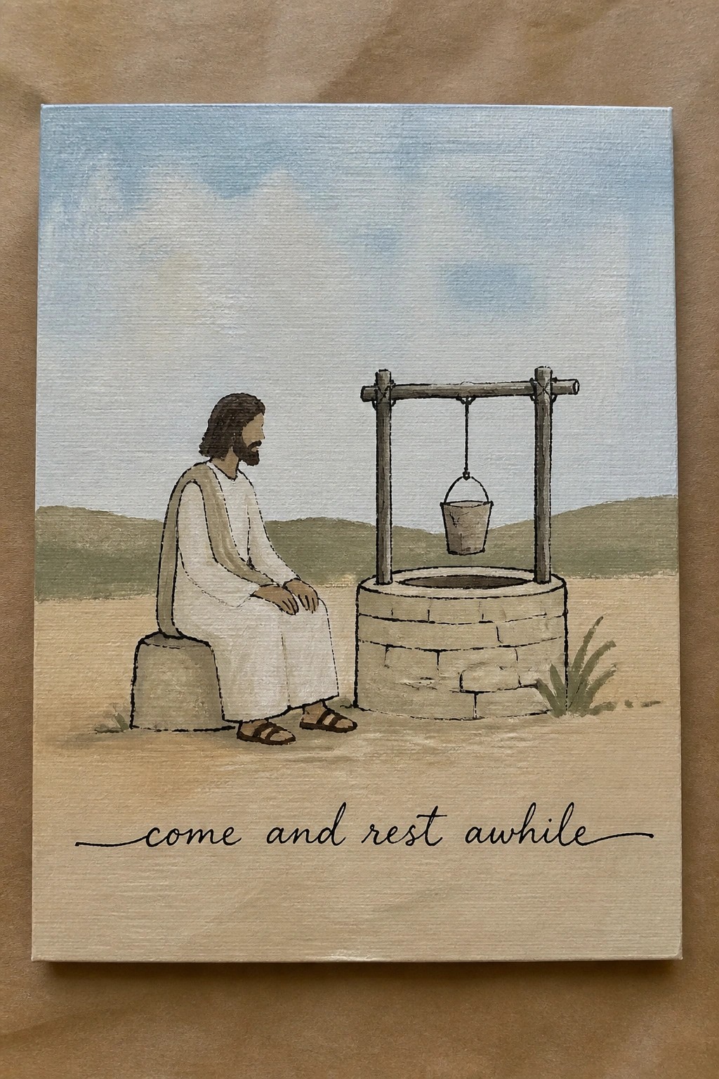 Jesus in white robe sits by stone well under blue sky with 