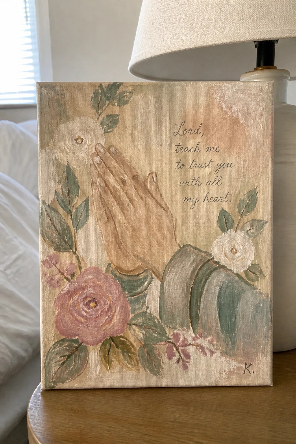 Painting of praying hands amid pink and white roses with trust quote on canvas