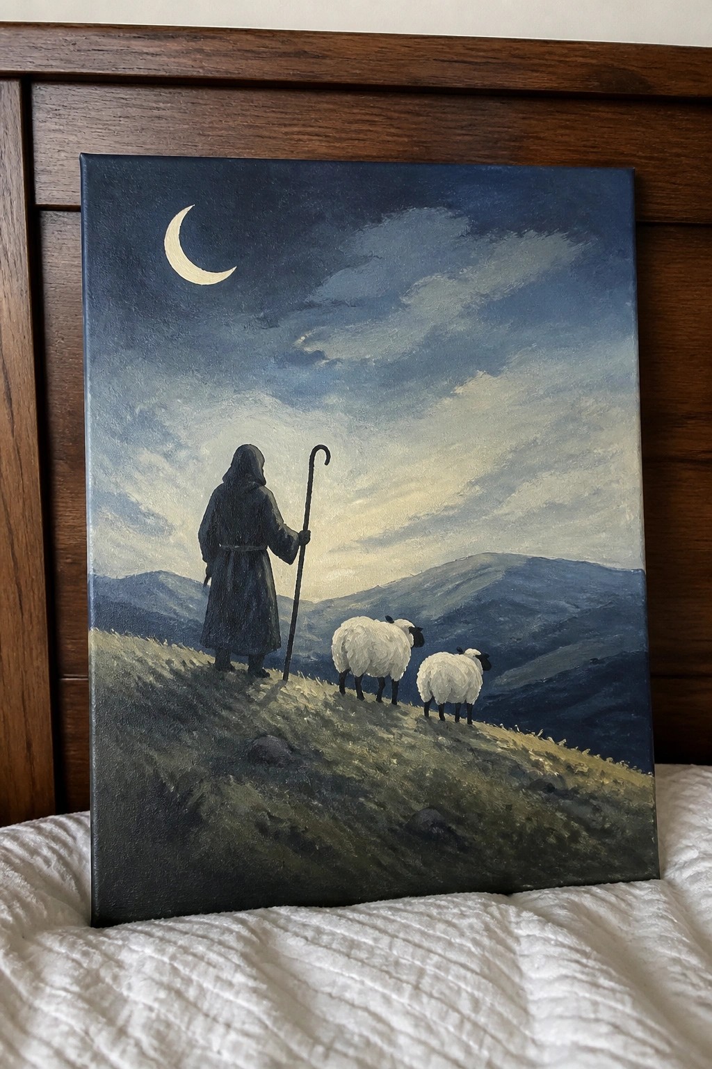 Dark-robed shepherd with staff and two sheep on hillside beneath crescent moon and cloudy sky