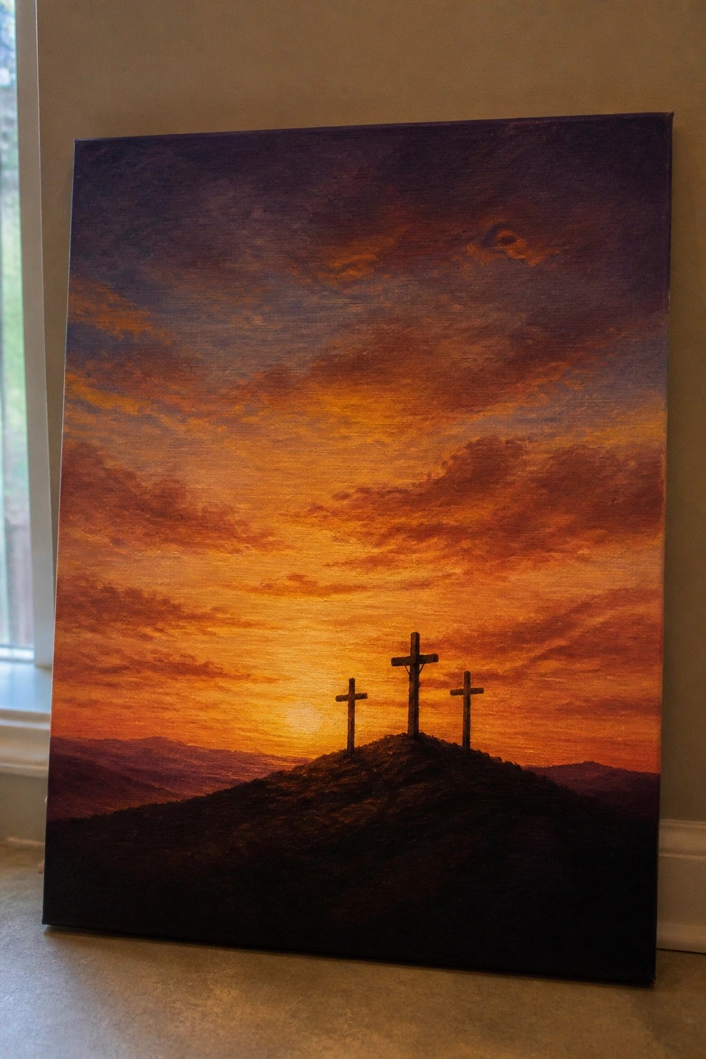 Three crosses on a hill silhouetted against a vibrant orange-purple sunset sky