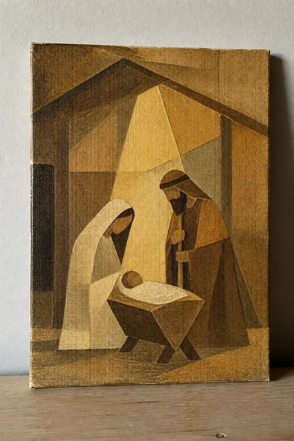 Geometric painting of veiled Mary, robed Joseph, baby in manger, light beams in brown tones.
