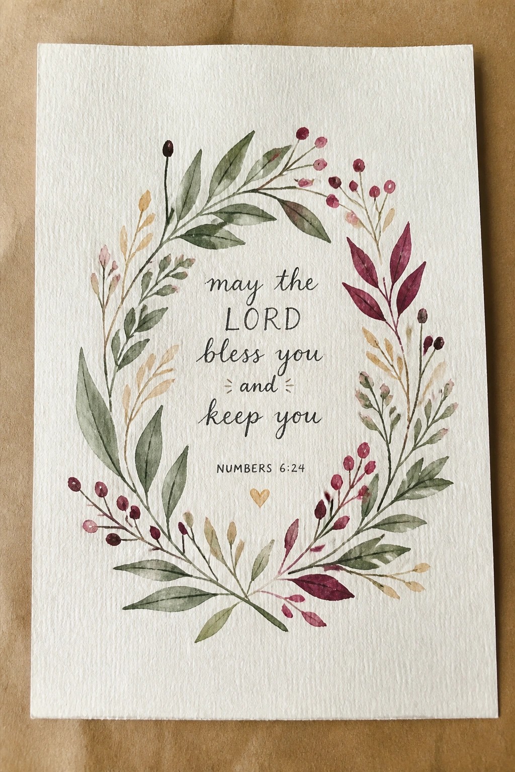 Watercolor wreath of green leaves and magenta berries encircling a blessing verse.