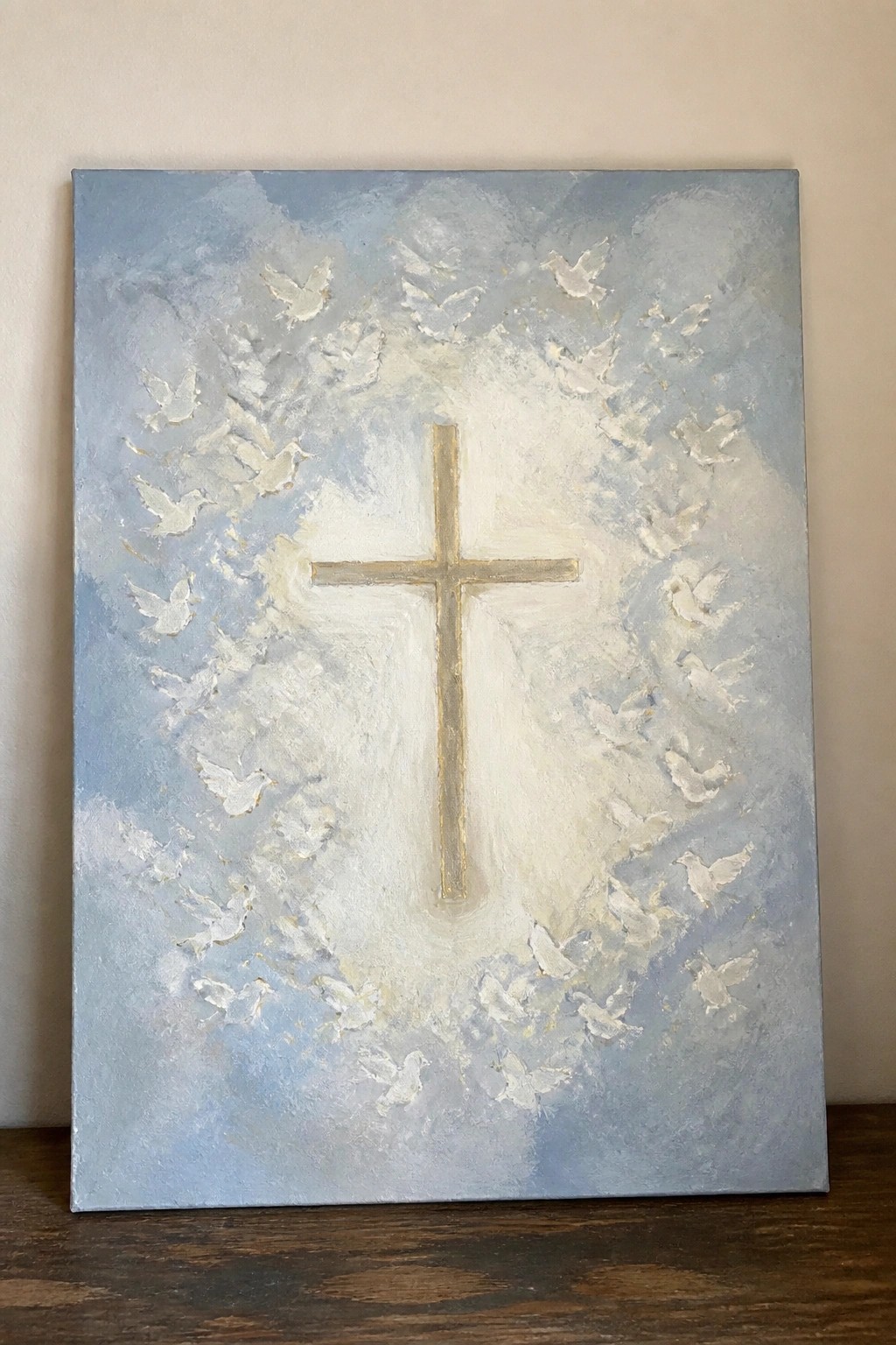Golden cross centered amid white doves on textured blue cloudy background