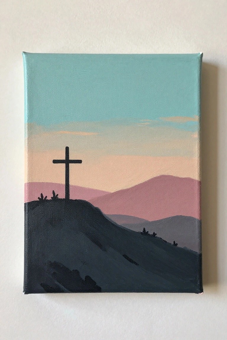 Silhouetted black cross atop dark hill with layered pink mountains and teal sky.