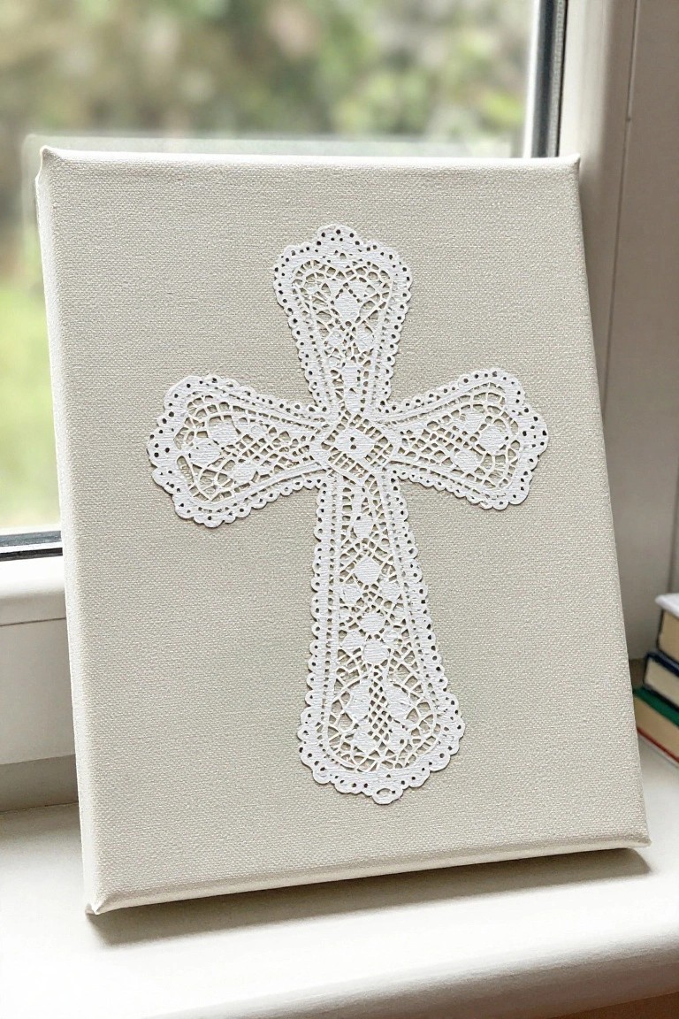 White lace cross centered on stretched canvas atop sunny windowsill.