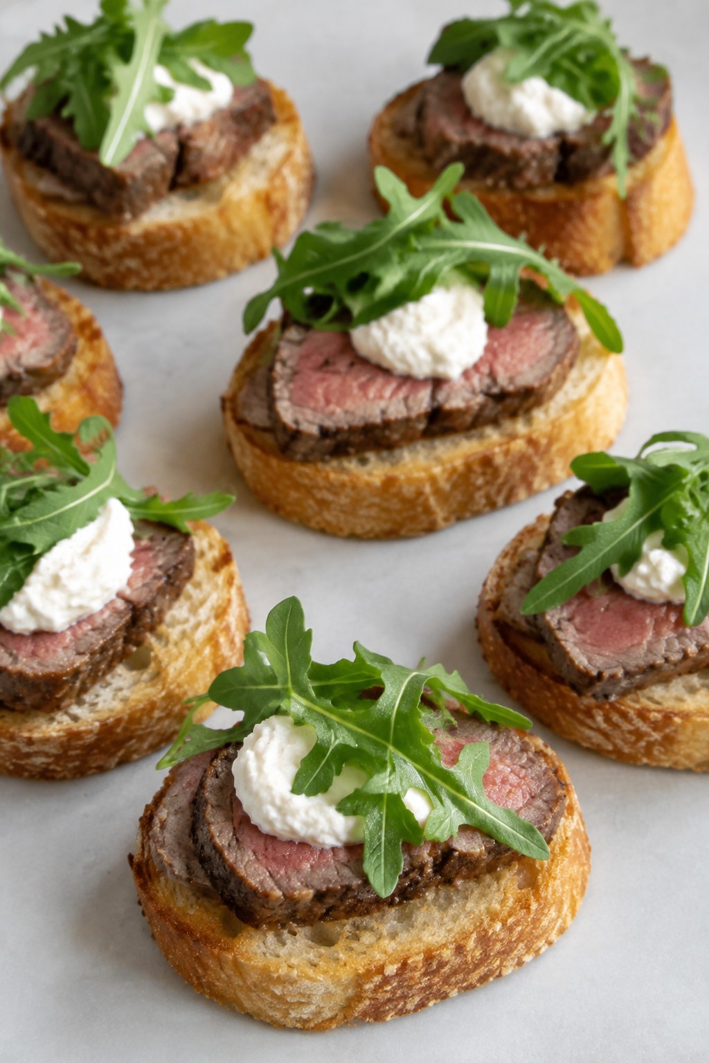 Beef Tenderloin Crostini with Horseradish Cream and Arugula