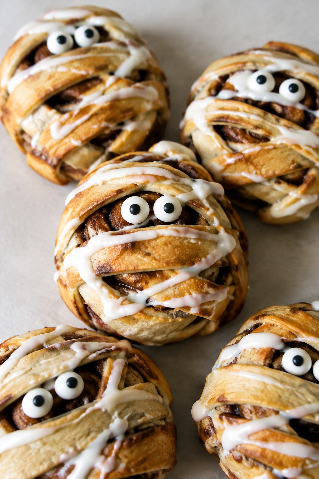 Mummy-Wrapped Cinnamon Rolls with Cream Cheese Icing
