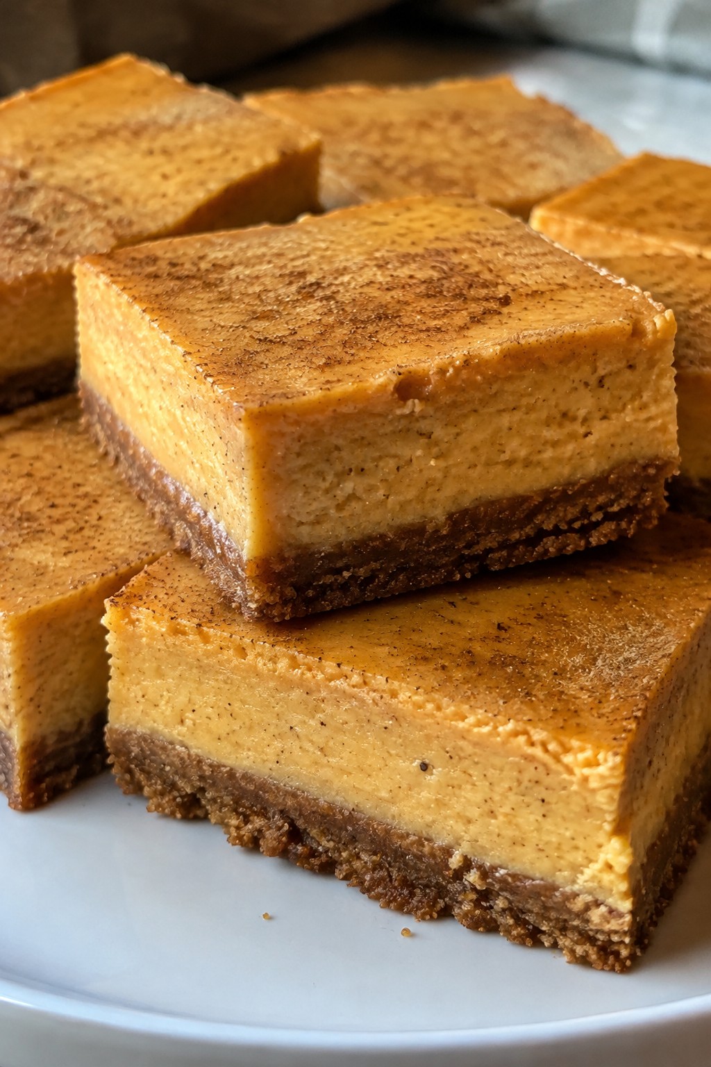 Spiced Pumpkin Cheesecake Bars with Gingersnap Crust
