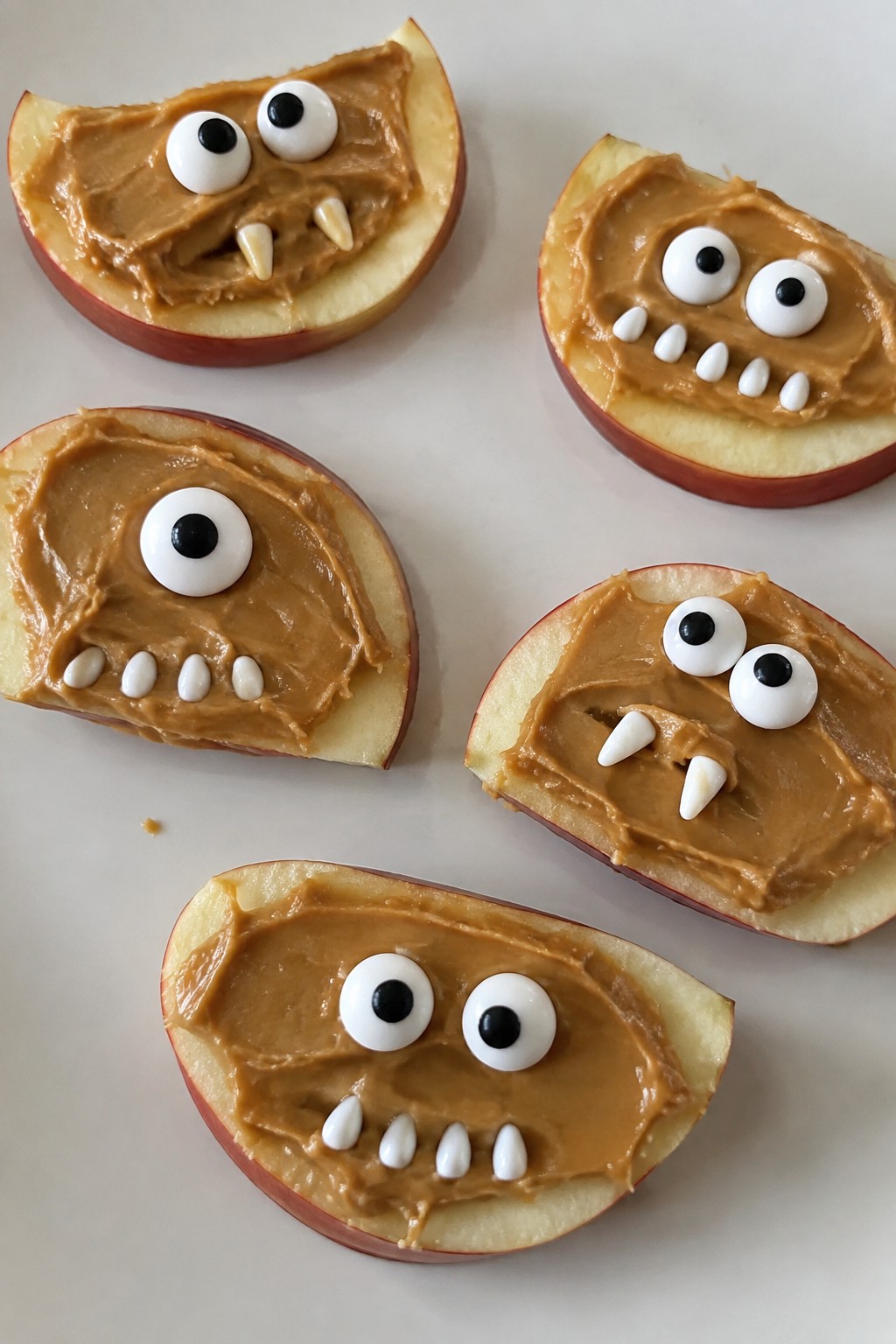 Monster Apple Slice Faces with Peanut Butter and Candy Eyes