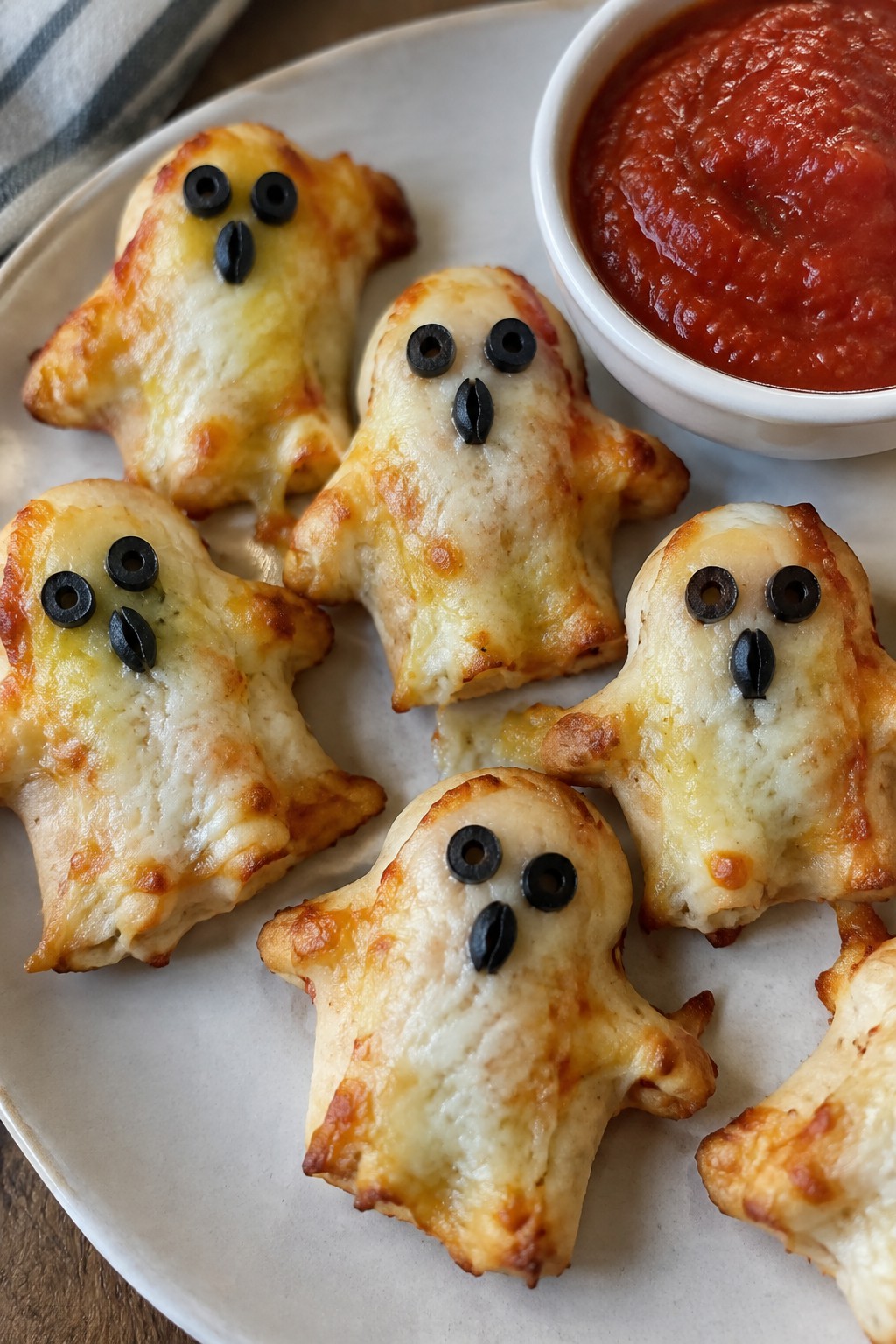 Cheesy Ghost-Shaped Pizza Bites with Marinara Dip