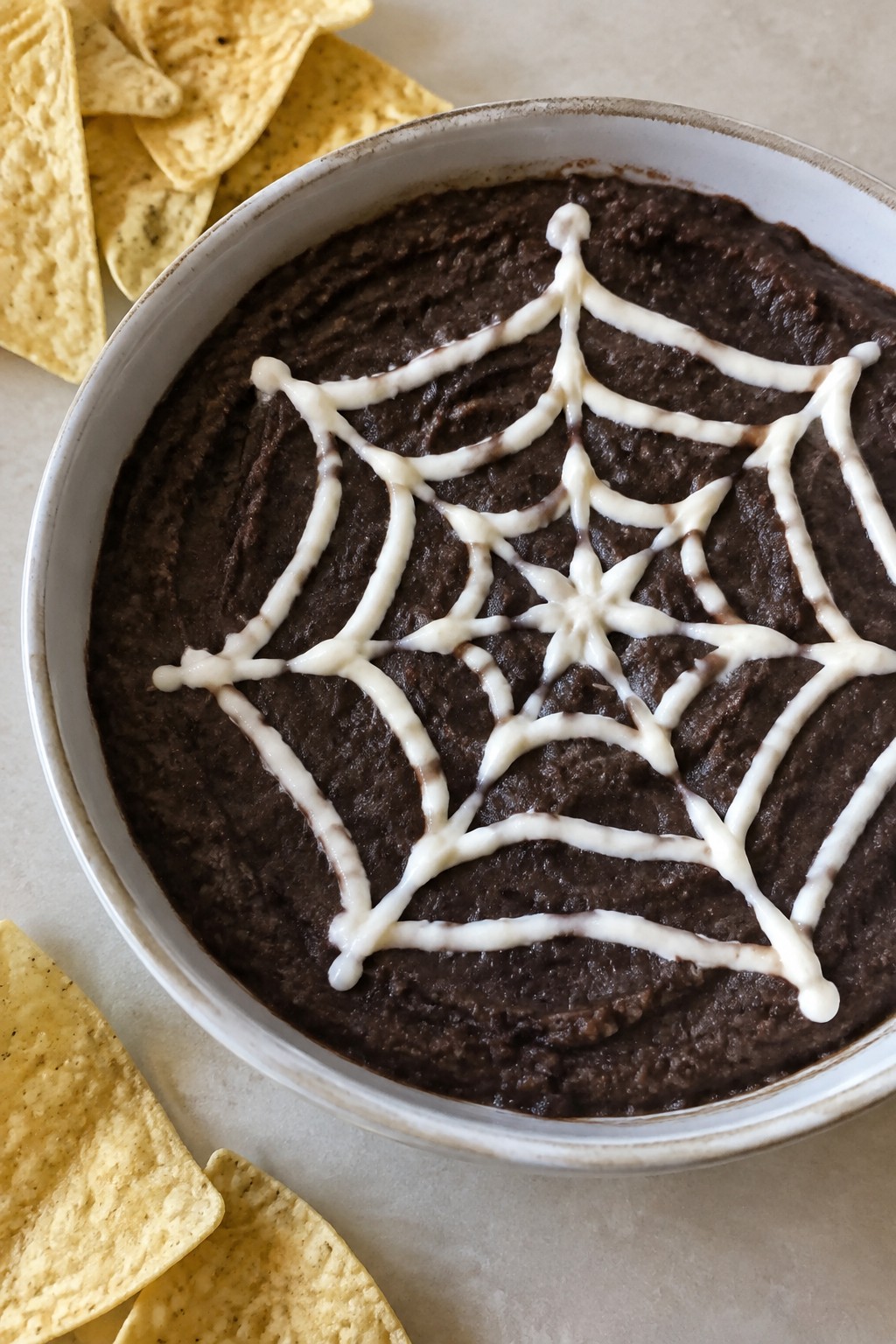 Spiderweb Black Bean Dip with Tortilla Chips