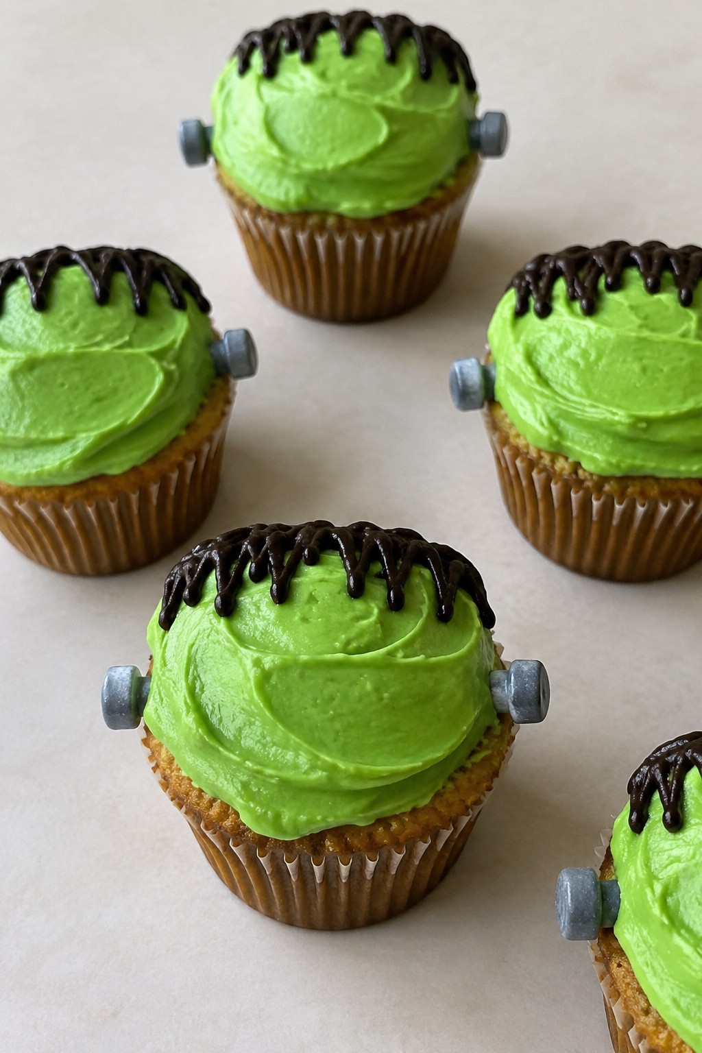 Apple Cider Frankenstein Cupcakes with Green Frosting and Candy Bolts