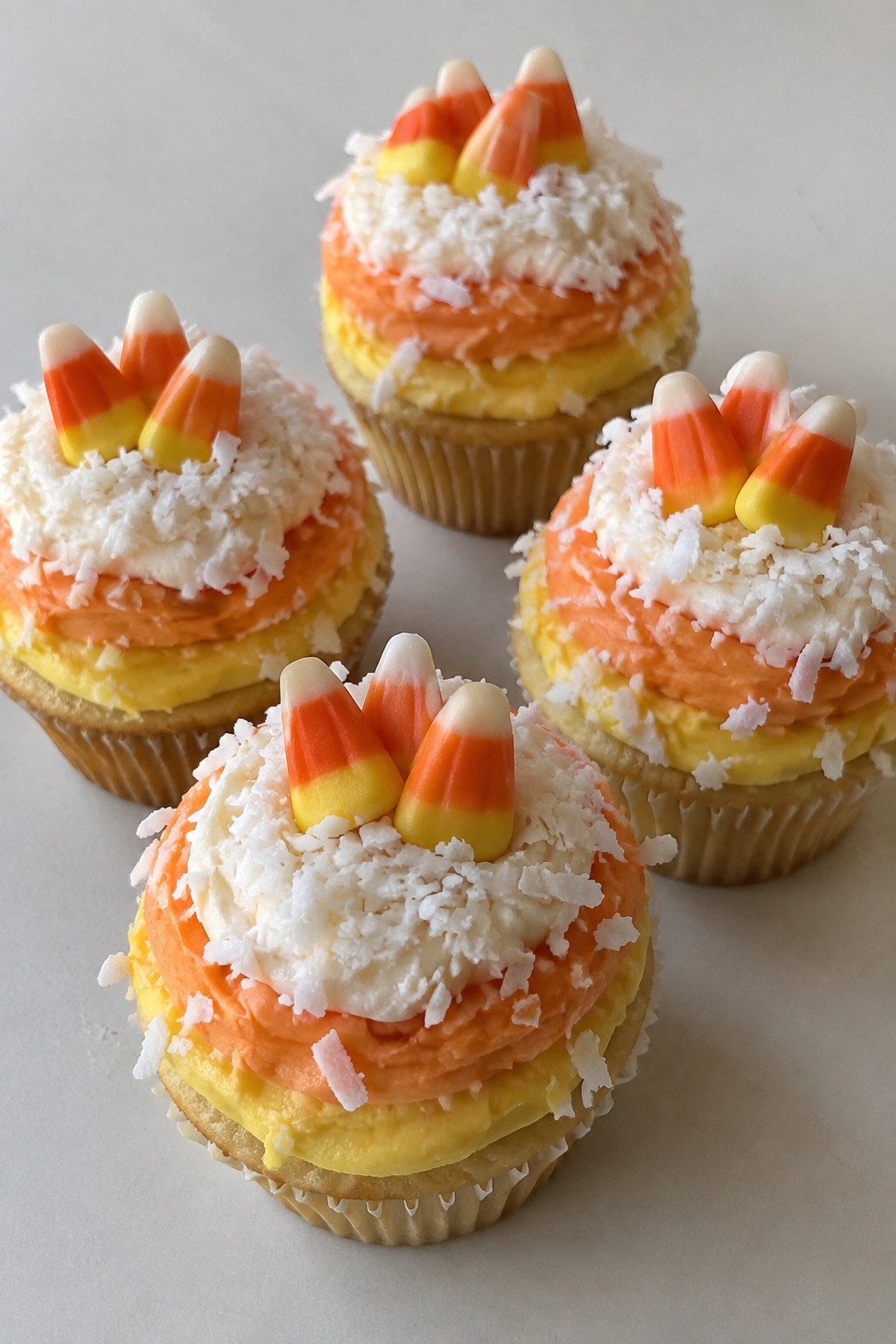 Coconut Candy Corn Cupcakes with Layered Frosting