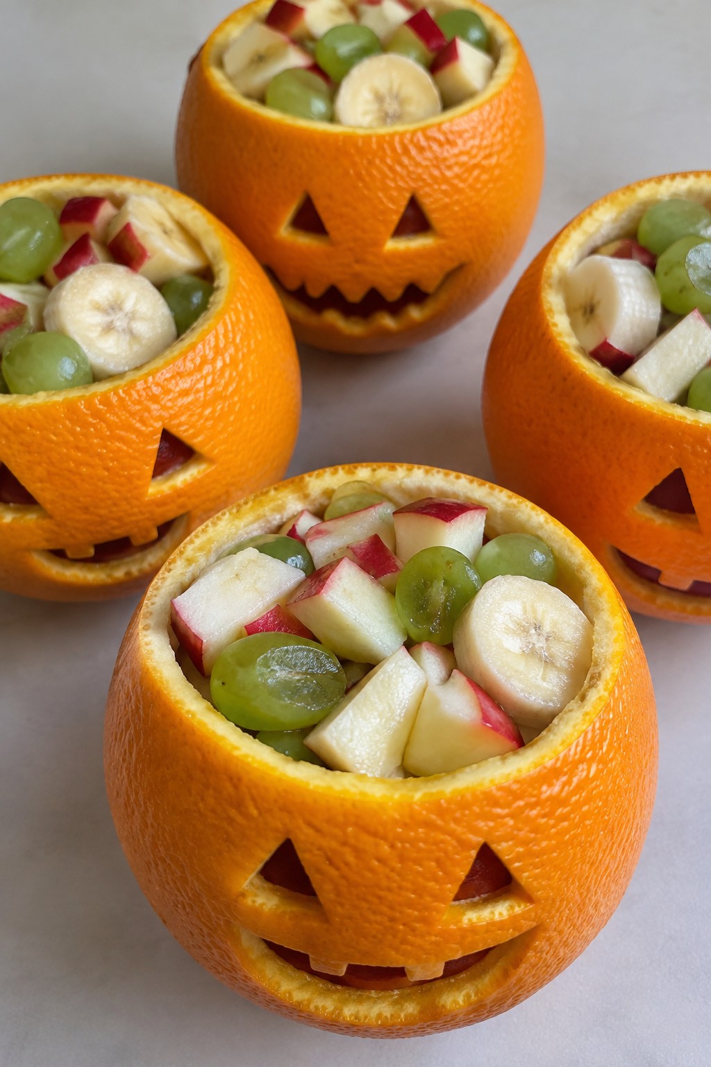Jack-o'-Lantern Stuffed Orange Cups with Fruit Salad
