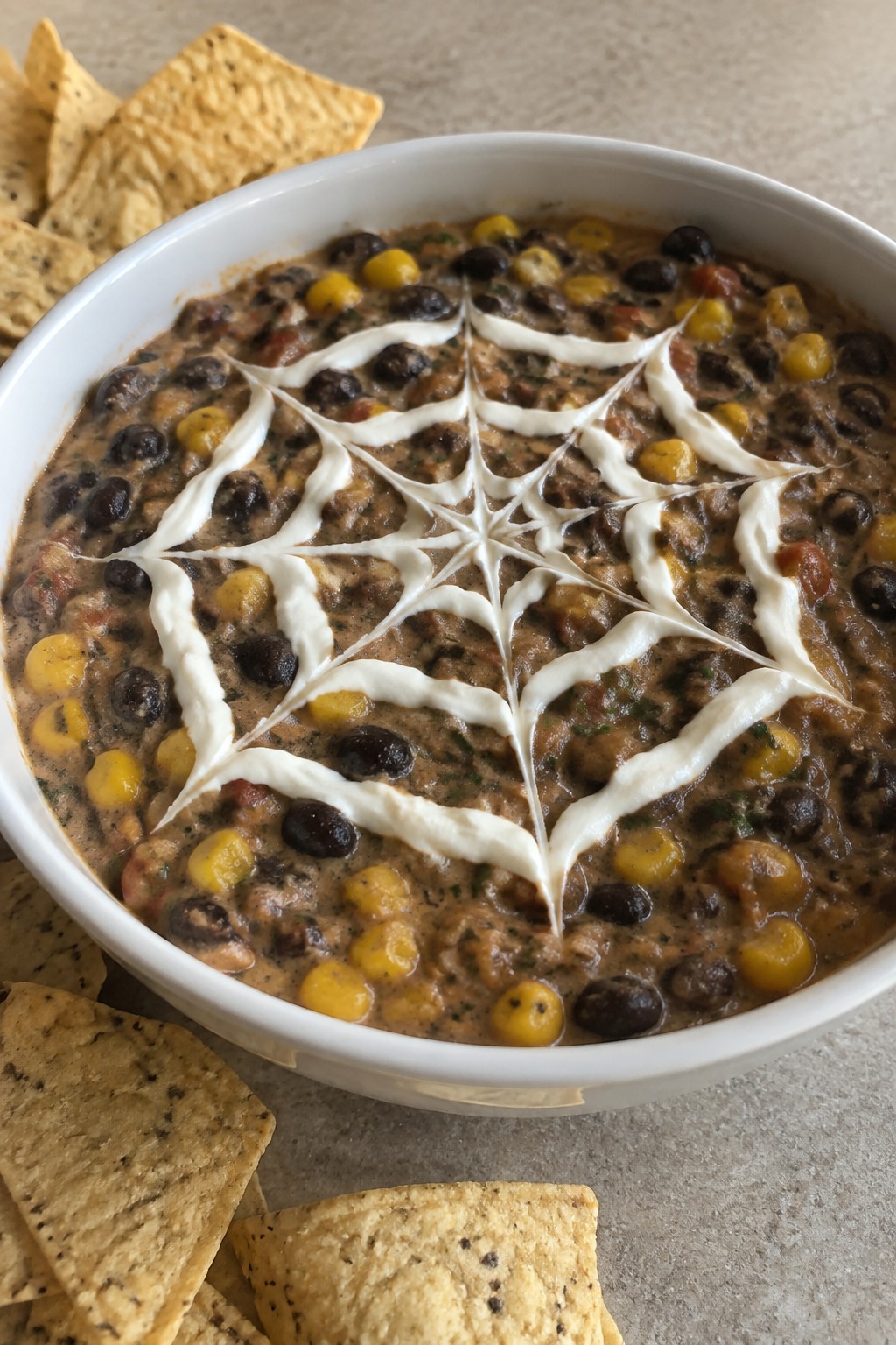 Spiderweb Black Bean and Corn Dip with Tortilla Chips