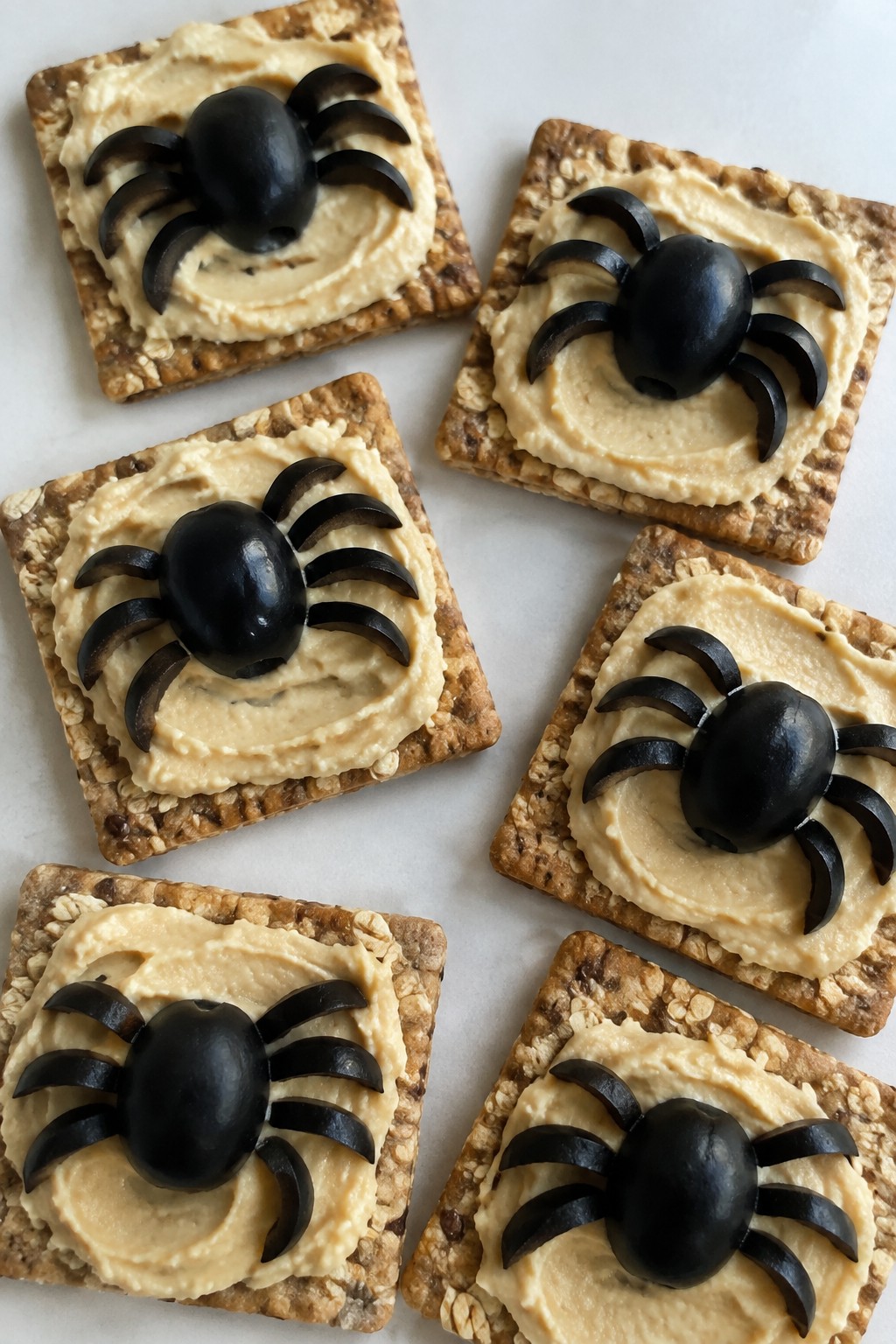 Olive Spider Bites on Whole Grain Crackers