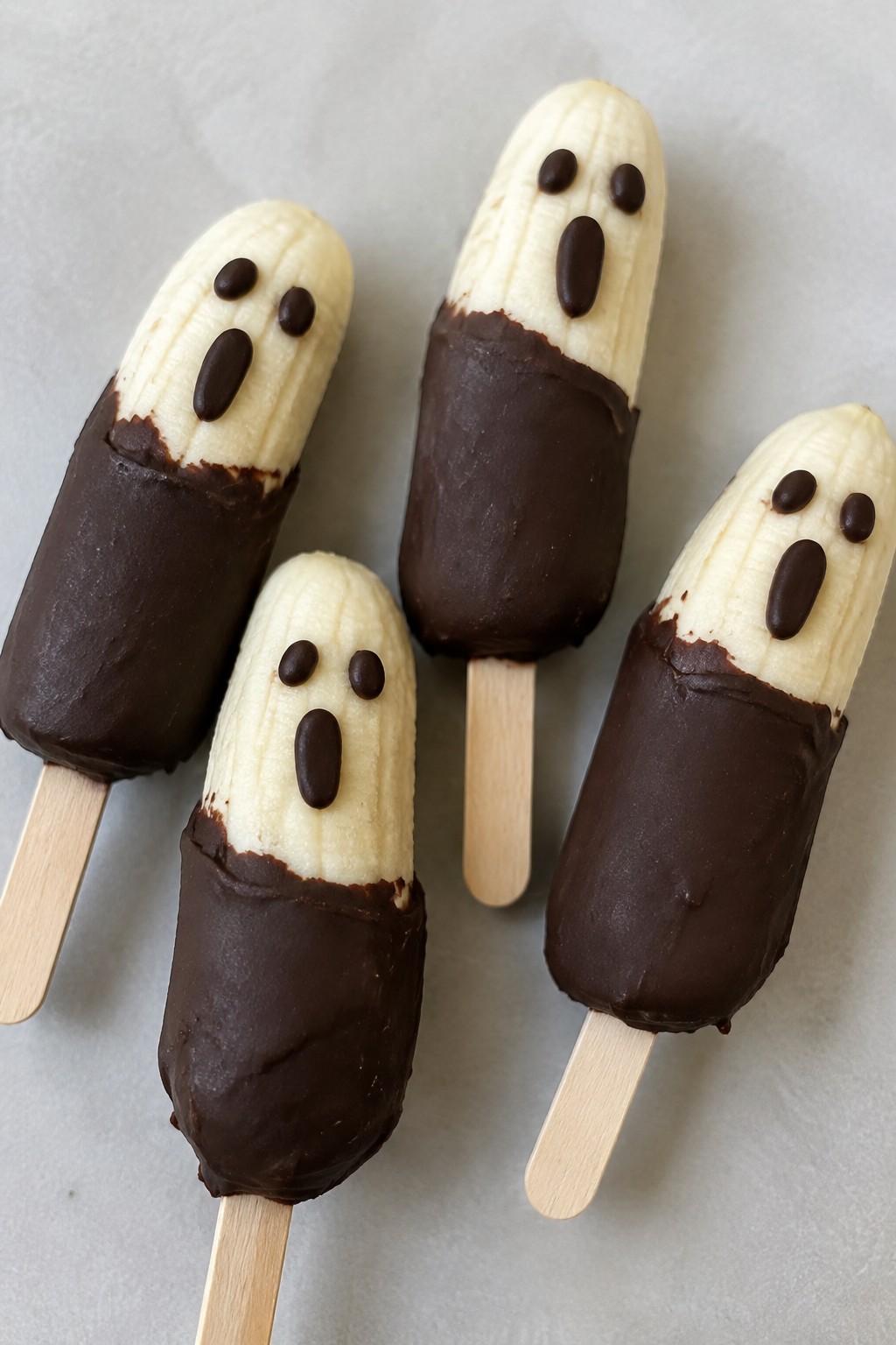 Frozen Banana Ghost Pops with Dark Chocolate Faces