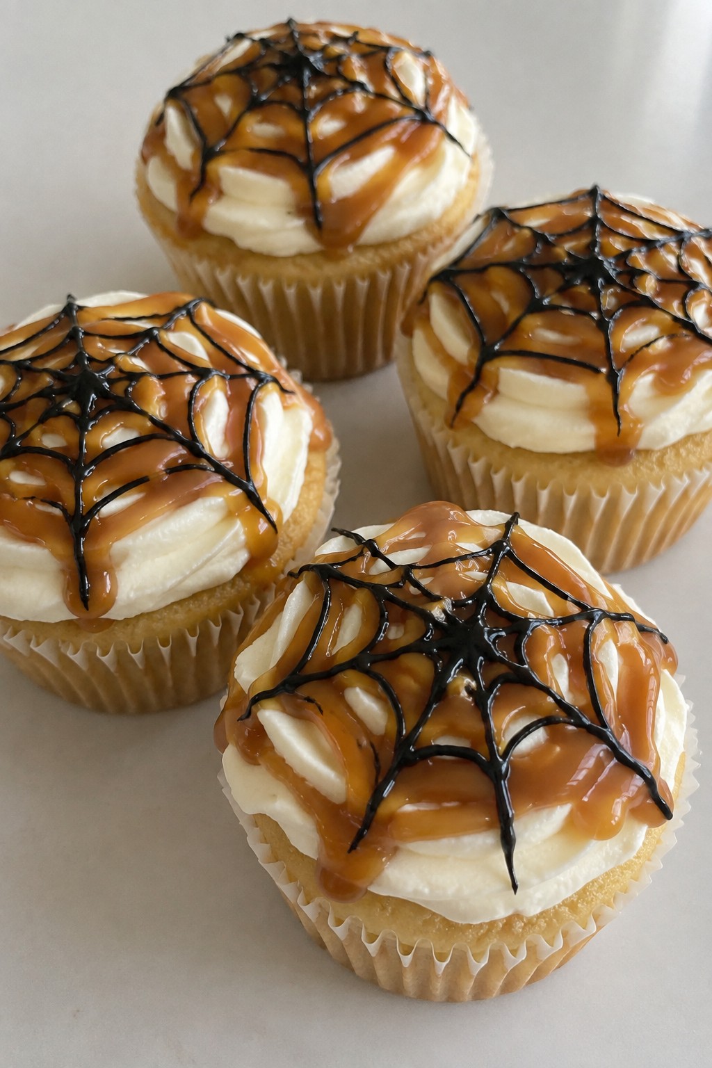 Spiderweb Caramel Drizzle Cupcakes