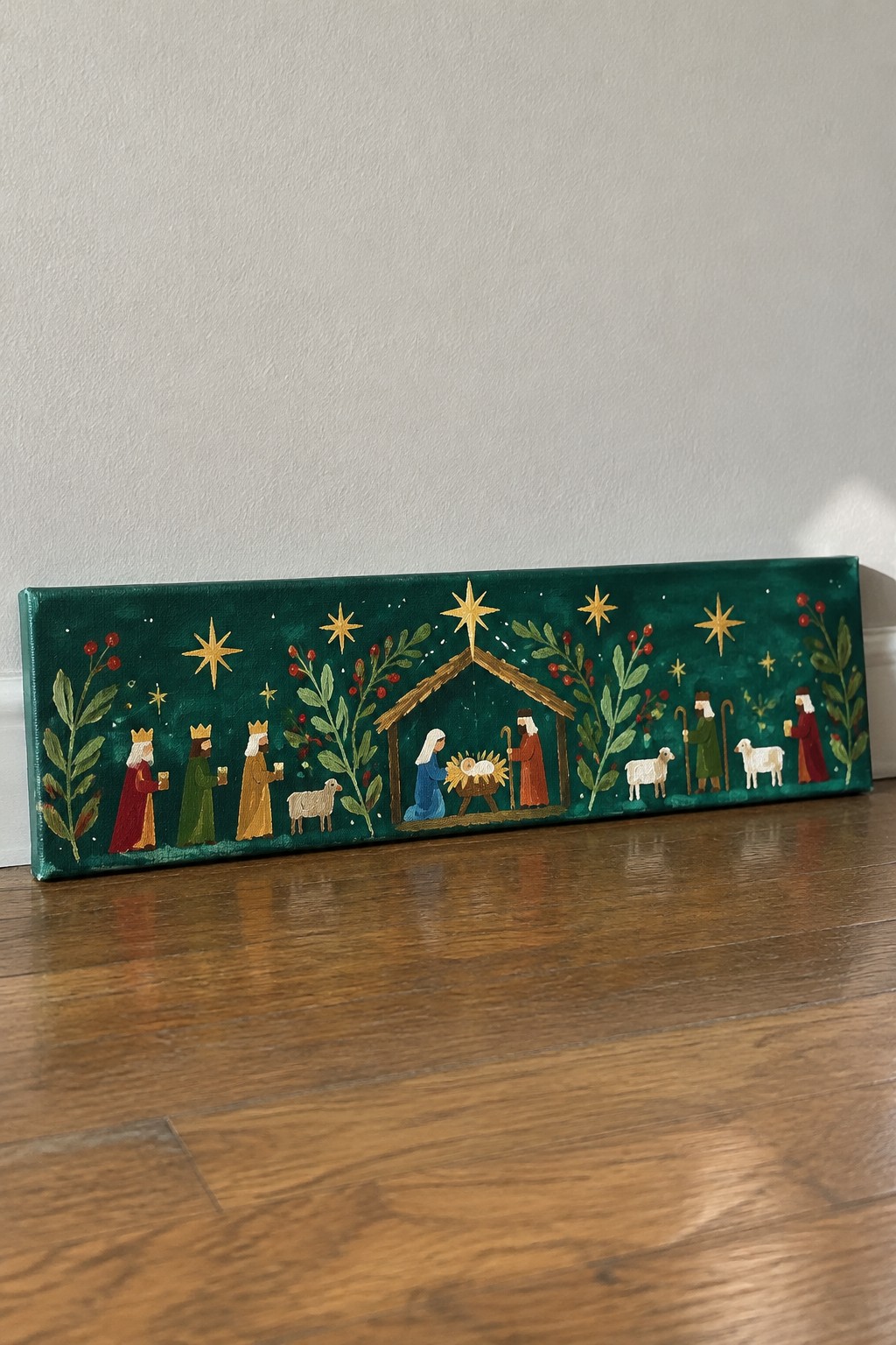 Folk art nativity on green canvas with kings, Mary, Joseph, shepherds, sheep and golden stars
