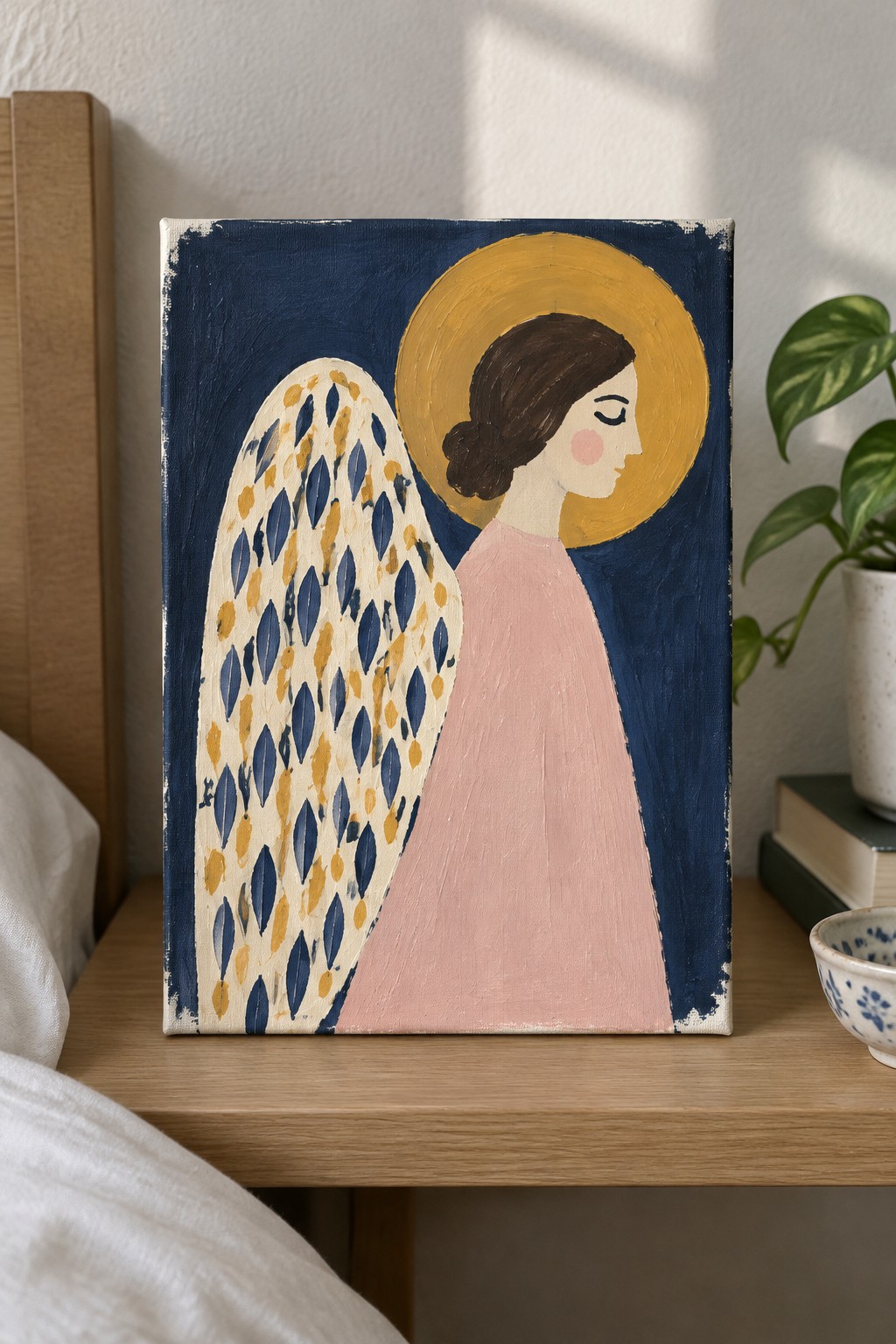 Angel in pink dress with large patterned wing and yellow halo on navy background
