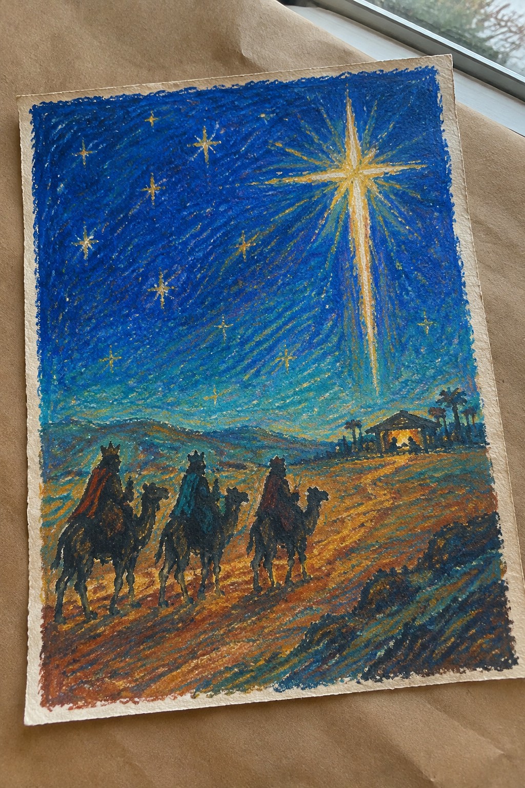 Three crowned kings on camels follow radiant star toward distant stable at night.
