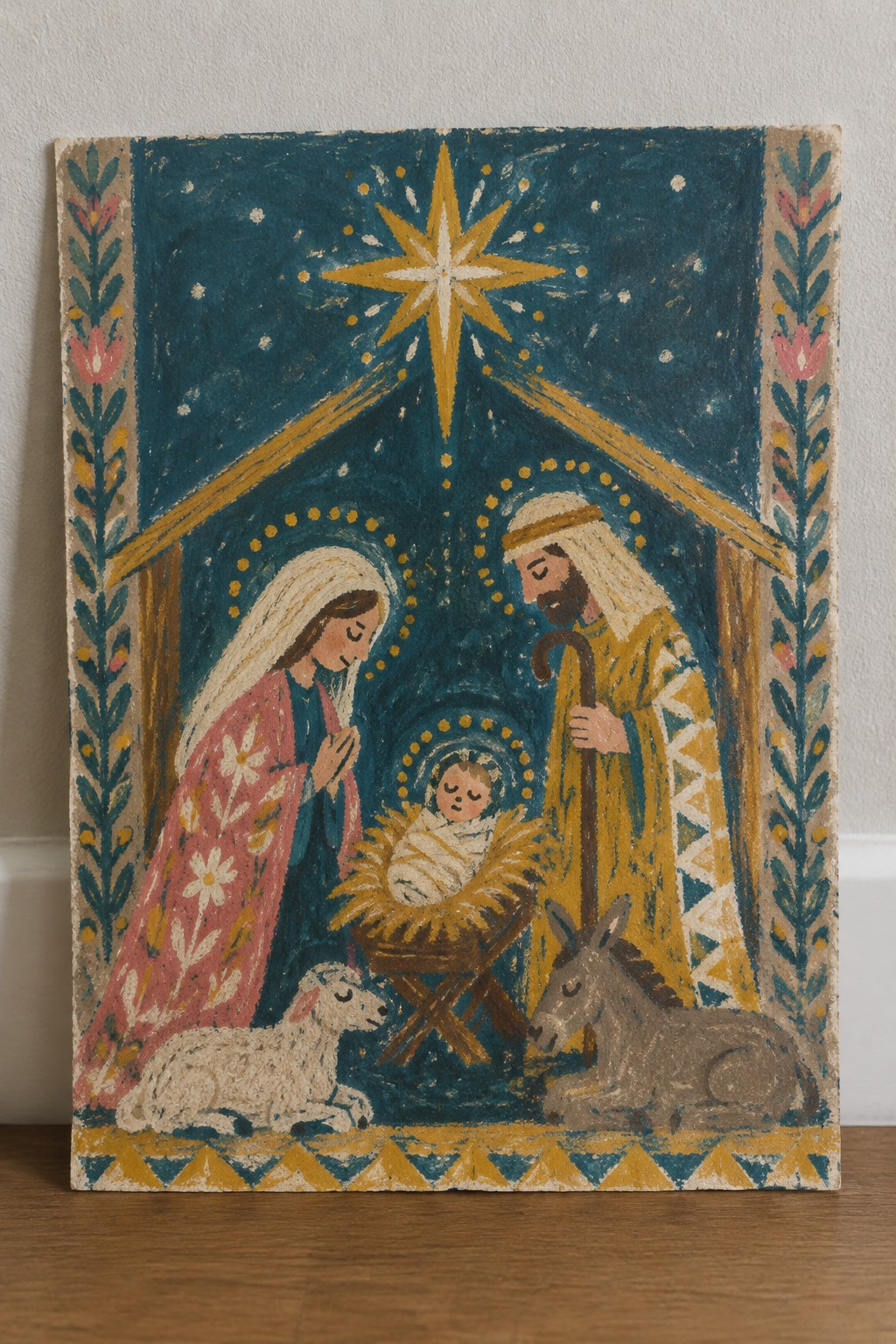 Folk painting of Mary in pink robe and Joseph beside manger with star and animals
