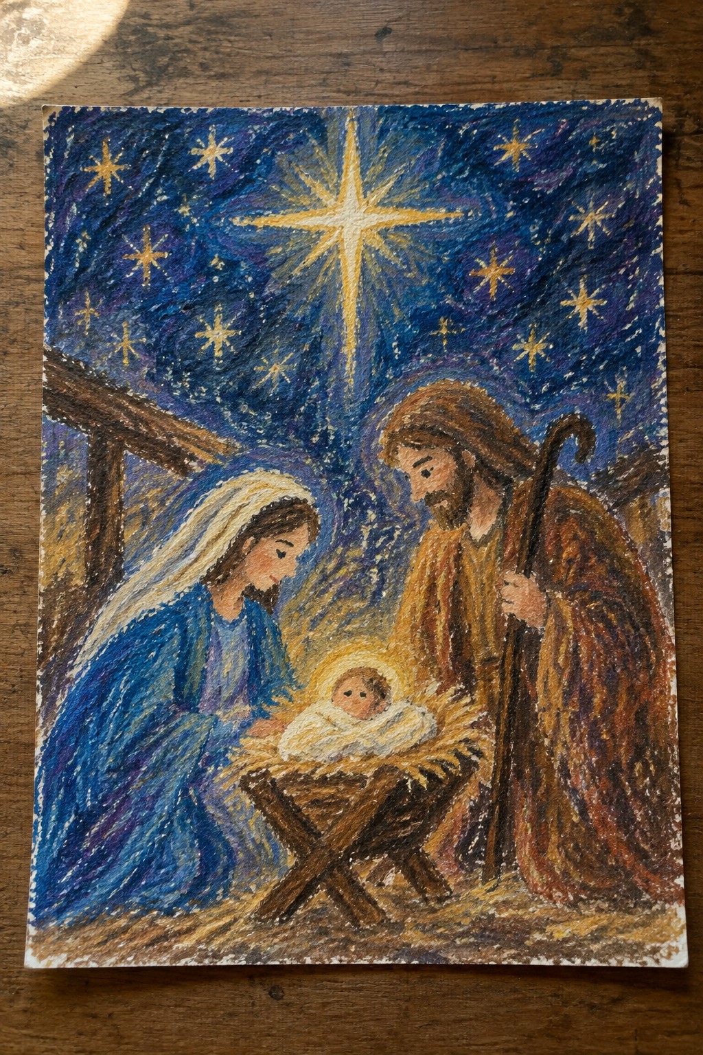 Nativity painting with Mary in blue veil, Joseph with staff, and glowing baby Jesus in manger under bright star