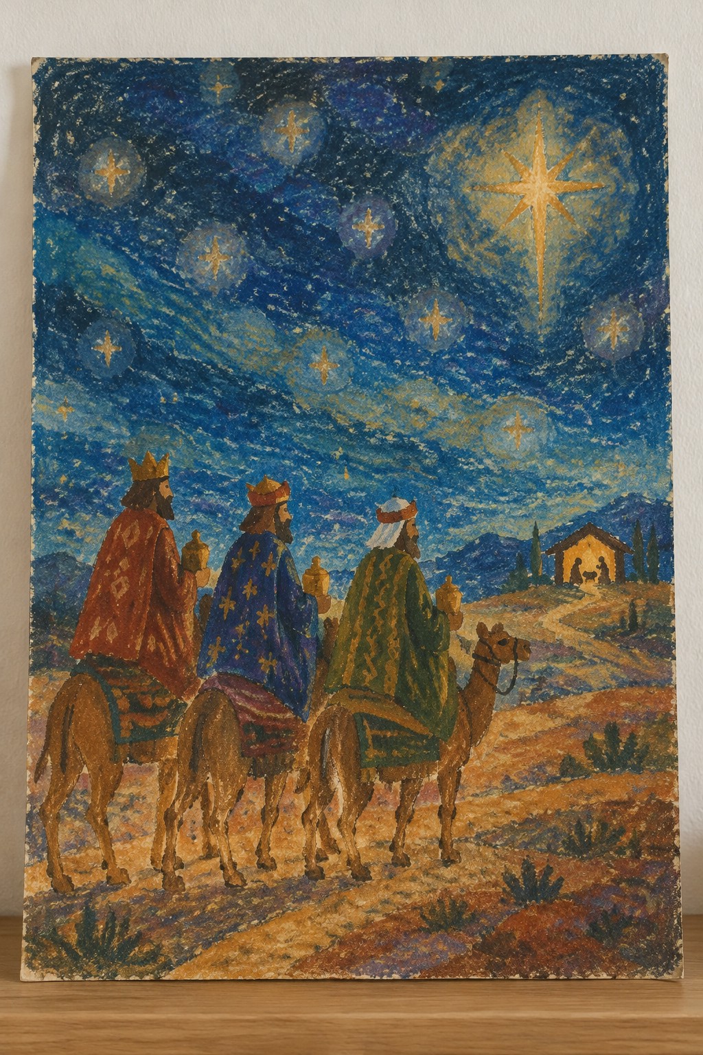 Three crowned kings in red, blue, and green ride camels toward a stable under a bright star.