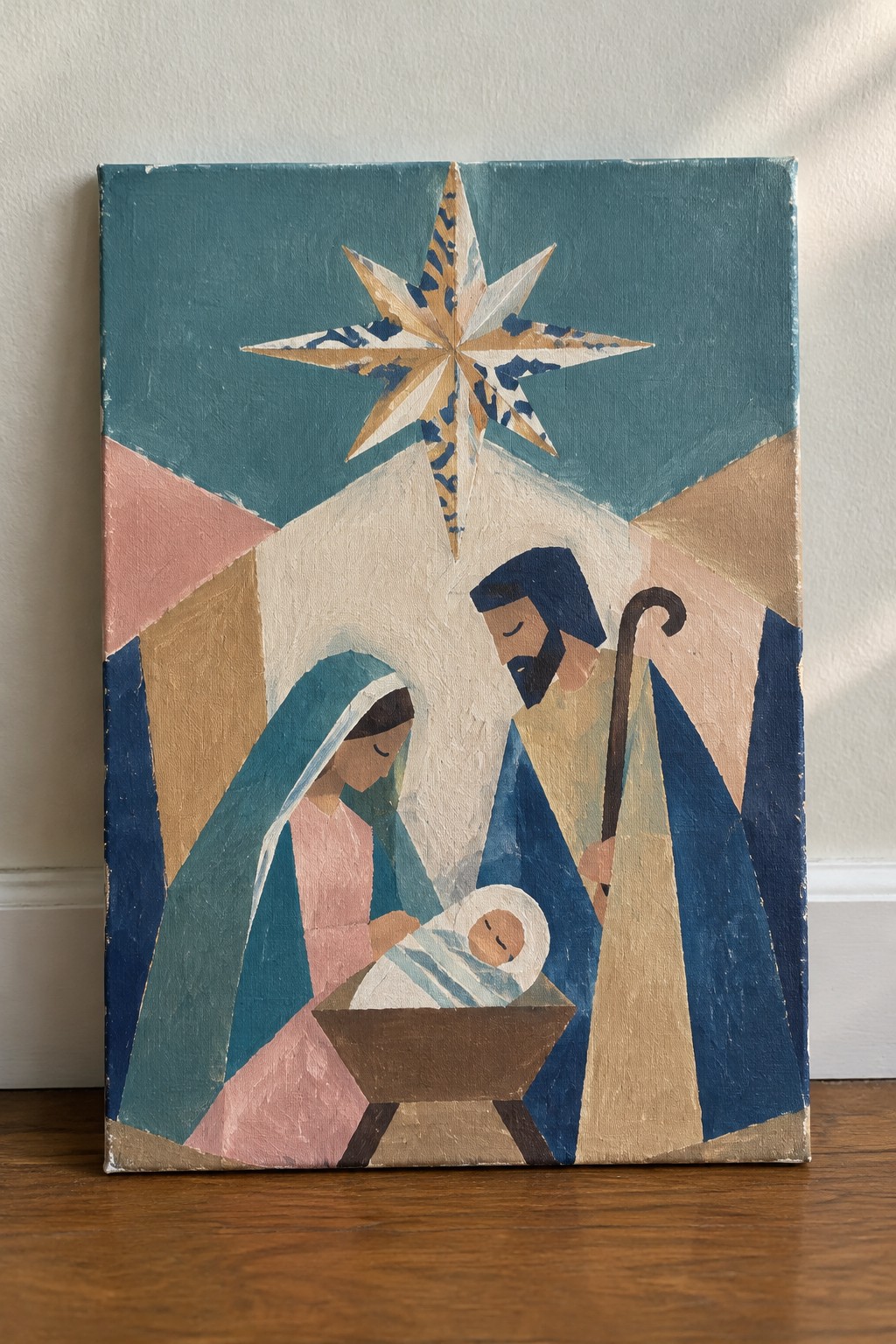 Abstract geometric Nativity scene with Mary, Joseph, infant in manger, and large star.