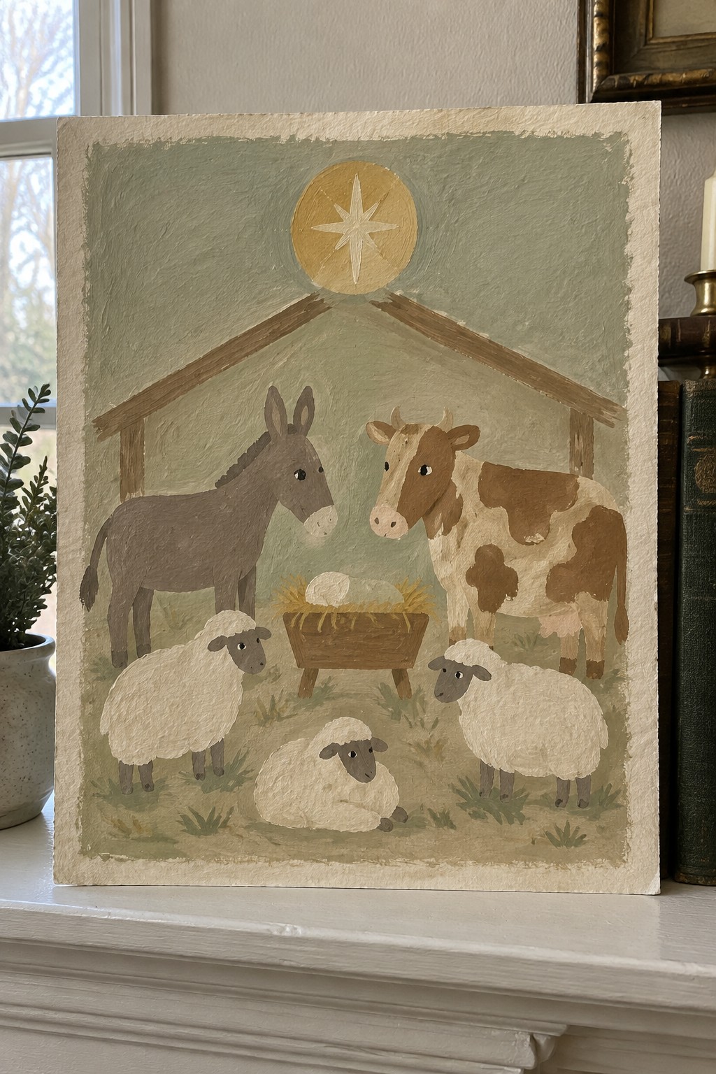 Nativity painting with donkey, cow, three sheep, manger, and star above stable