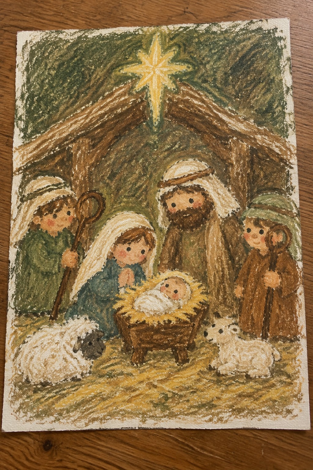 Colorful crayon nativity with baby in manger, Mary, Joseph, shepherds, sheep, and glowing star.