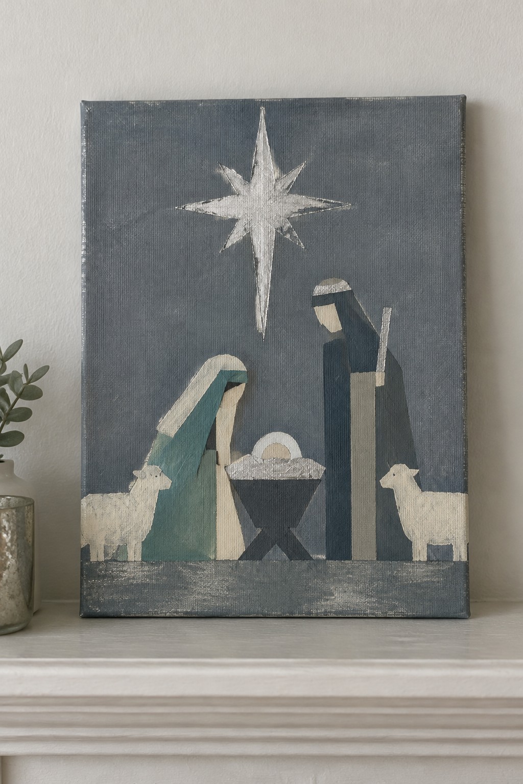 Geometric nativity painting with star, Mary, Joseph, manger, and two sheep in blue tones