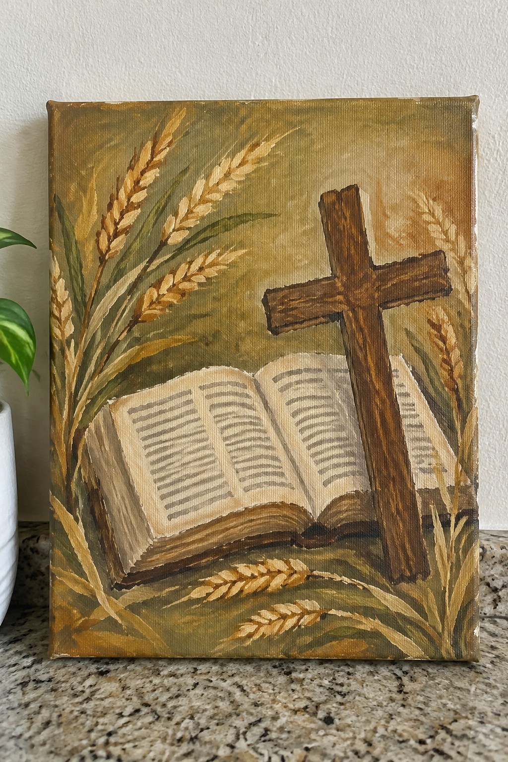 Acrylic painting of an open book, wooden cross, and golden wheat stalks in earthy tones