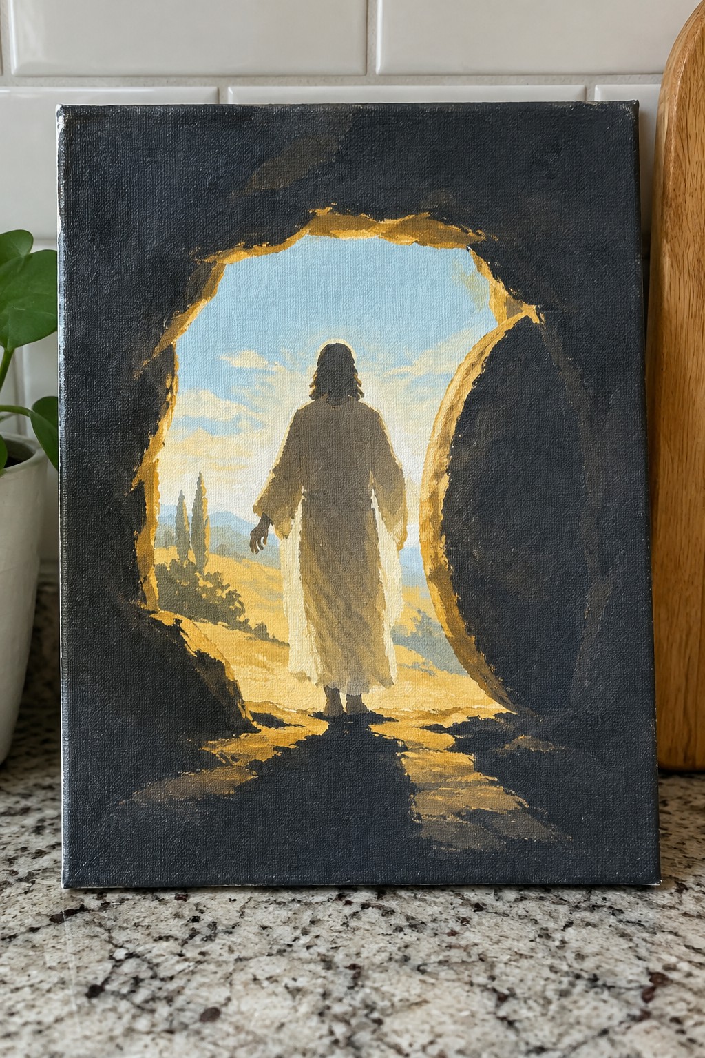 Robe-clad figure walks from dark cave into bright landscape of hills and trees