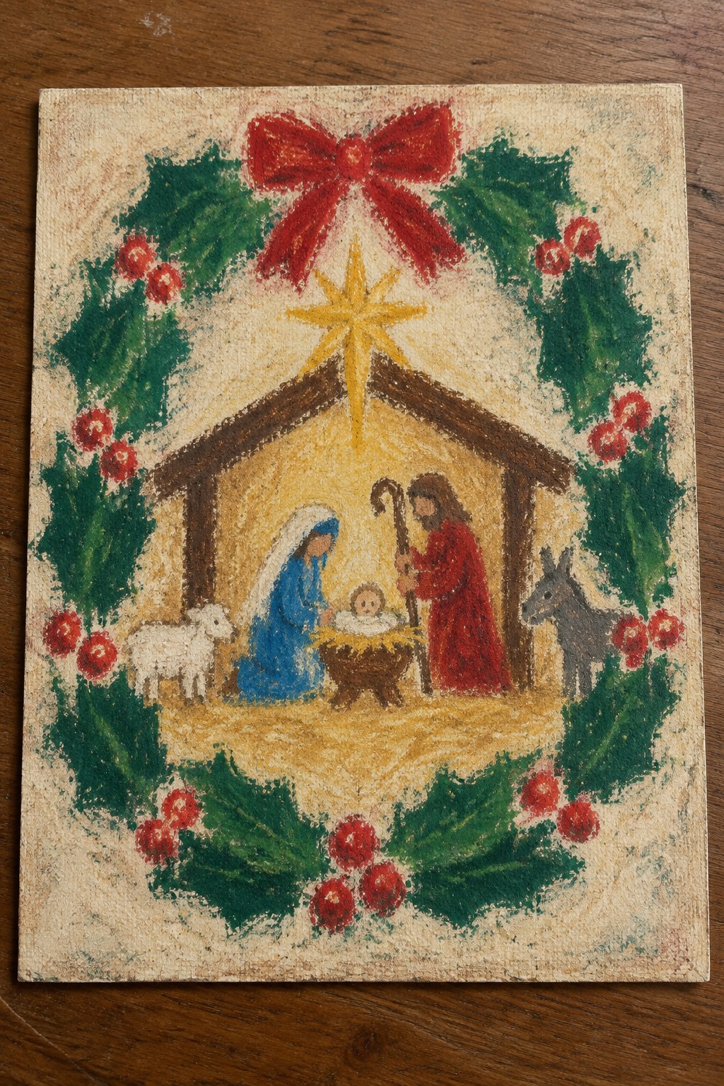 Pastel nativity with Mary in blue, Joseph in red, lamb, donkey, star and holly wreath with bow