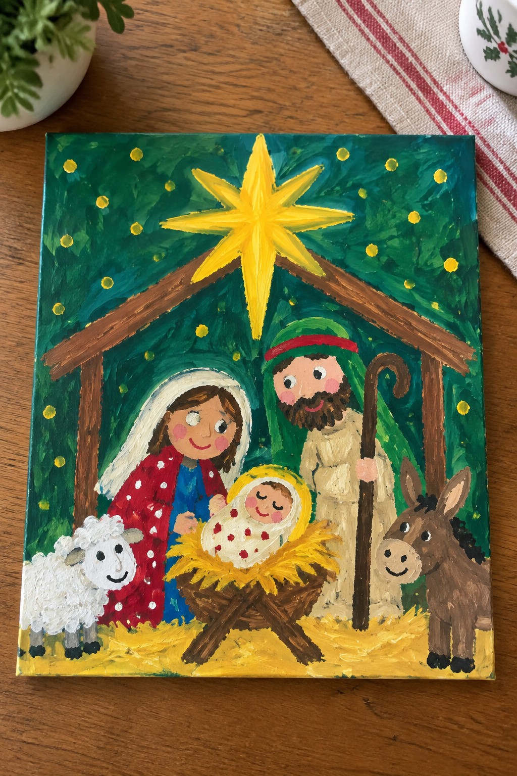 Colorful folk painting of nativity with Mary in red cloak, Joseph, baby, sheep, donkey, yellow star.