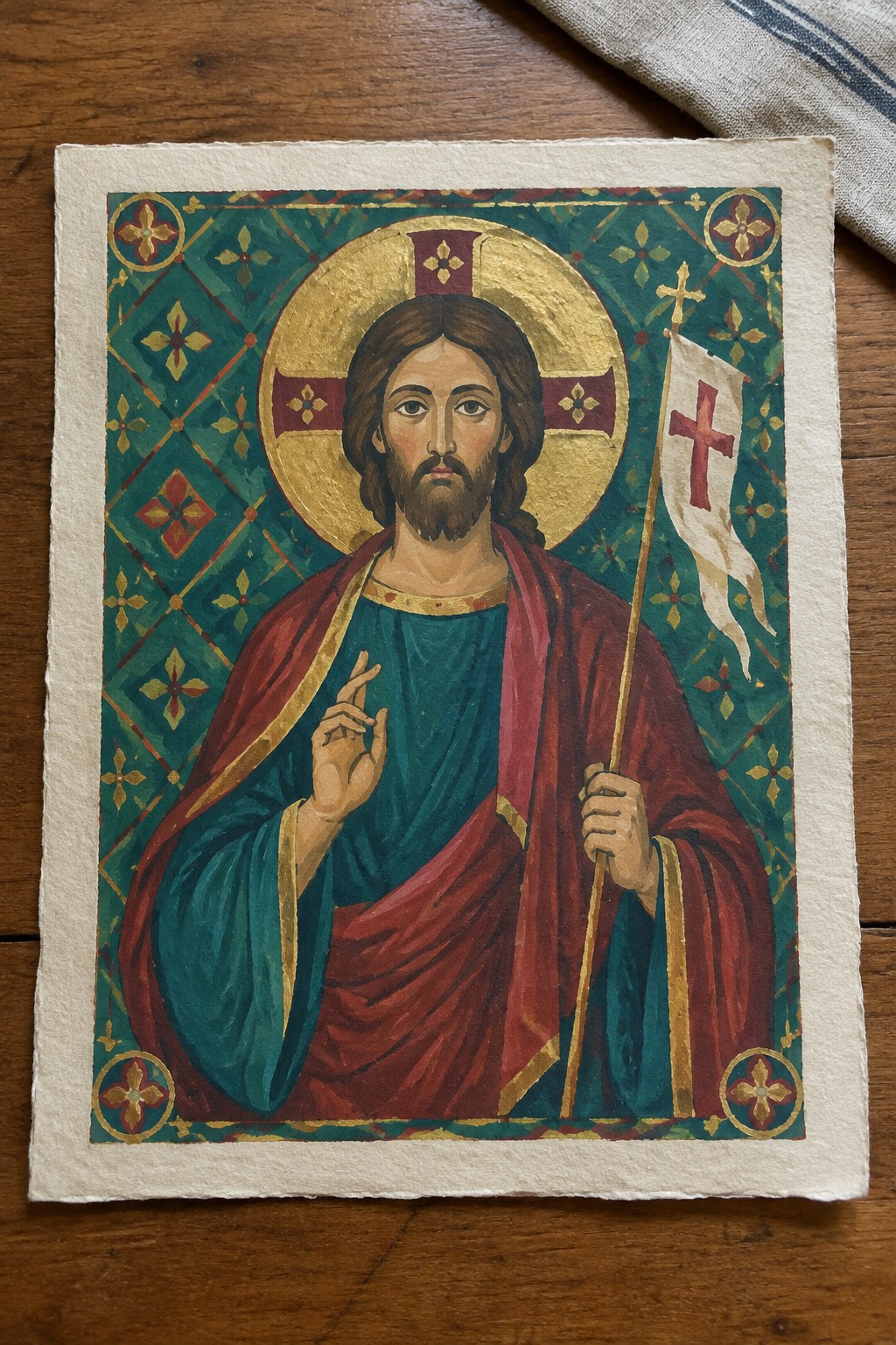 Byzantine icon of Jesus in teal robe and red cloak holding cross banner with golden halo