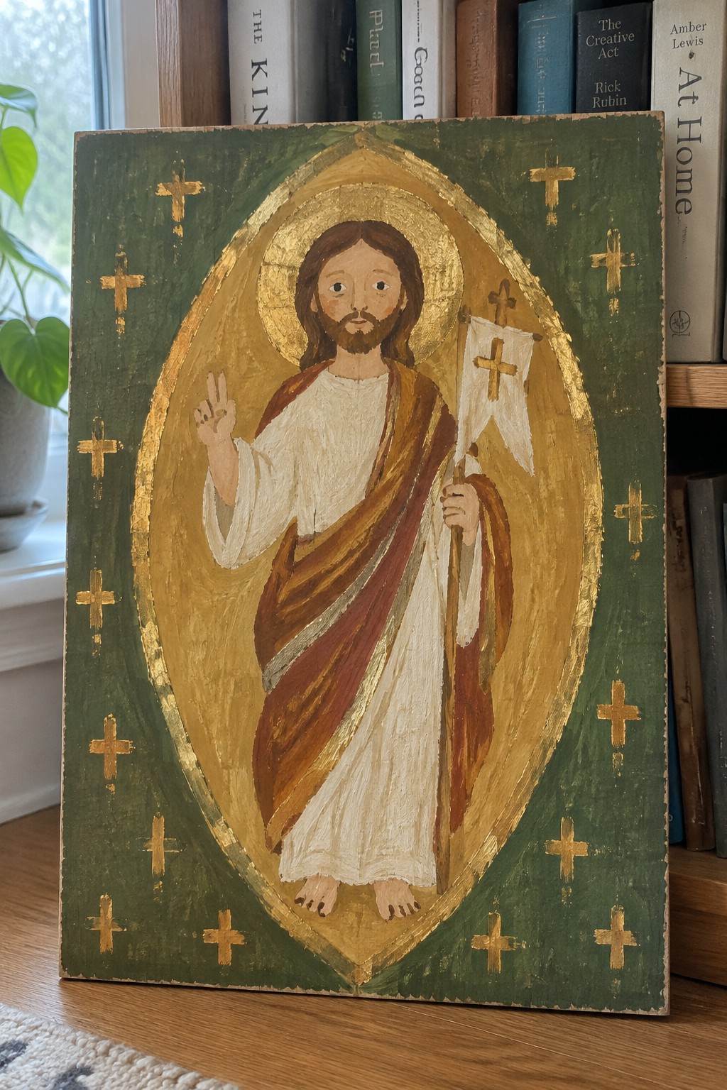 Folk art Jesus icon in white robe with halo holding cross flag on green panel with gold crosses