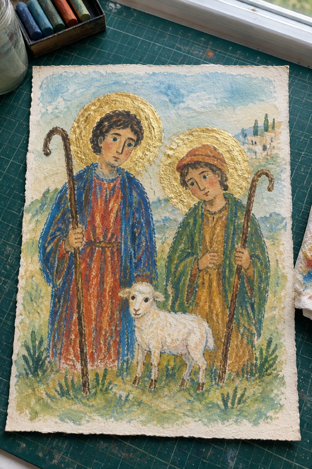 Two haloed youths in colorful robes hold crooks beside a white lamb in watercolor landscape