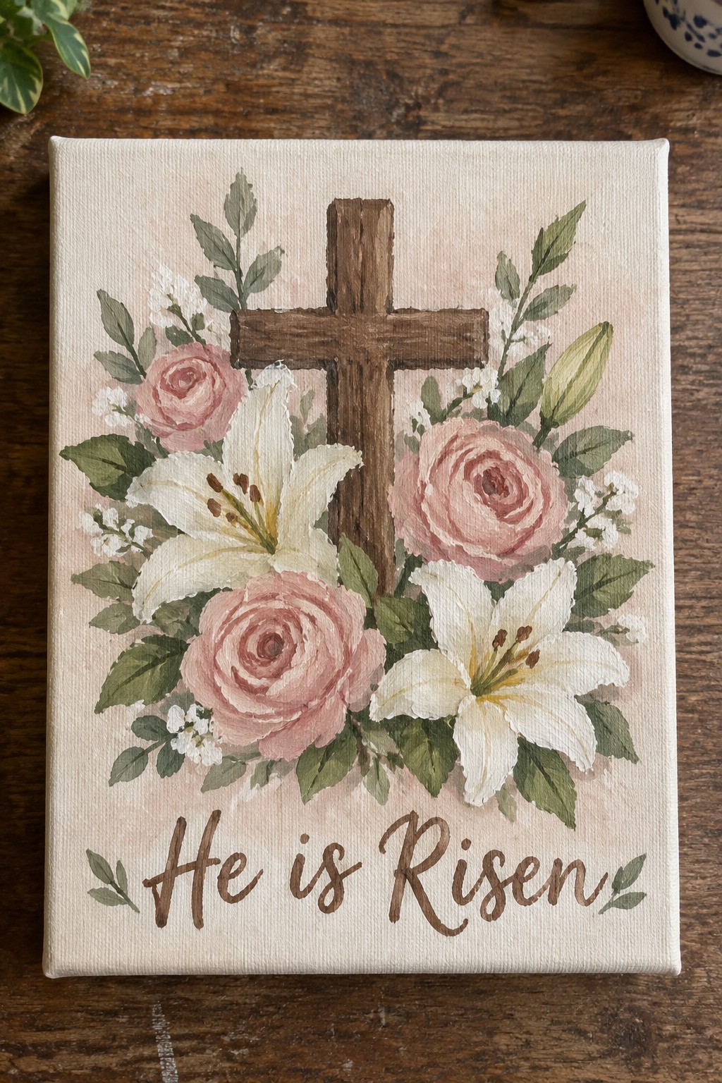 Wooden cross with pink roses, white lilies, and greenery above