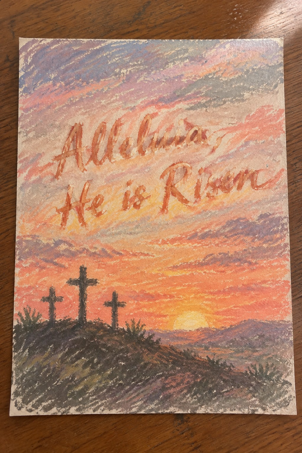 Watercolor sunset with three crosses on a hill and