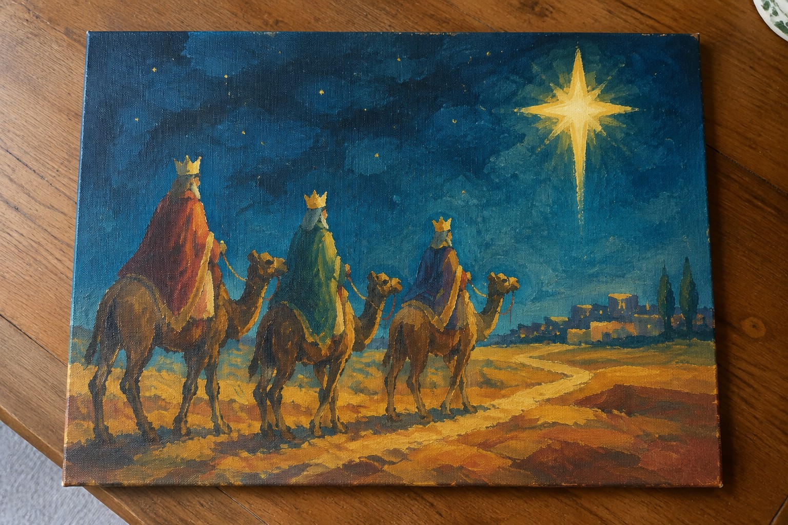 Three crowned kings in red, blue, and yellow robes ride camels under a bright star.