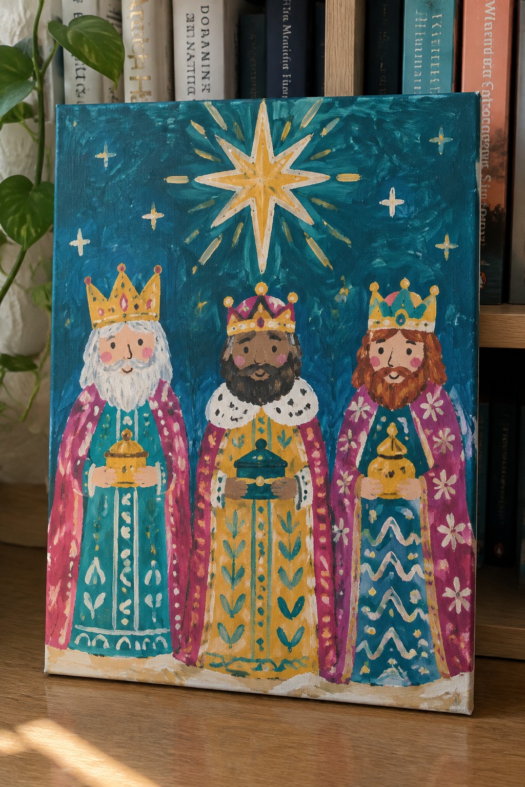 Folk art painting of three crowned kings holding gifts under a golden star