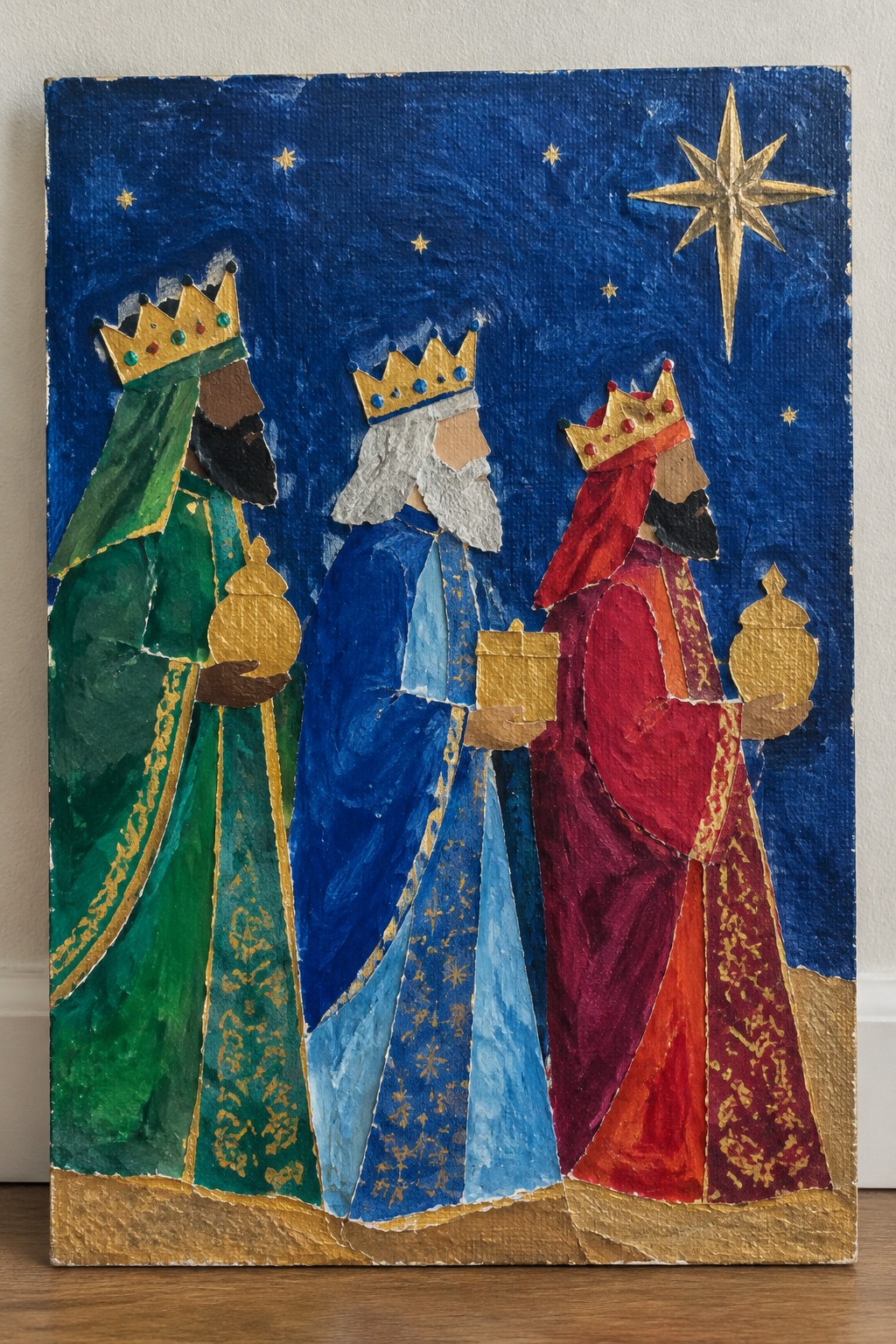 Three crowned kings in green, blue, and red robes holding golden gifts under a star.
