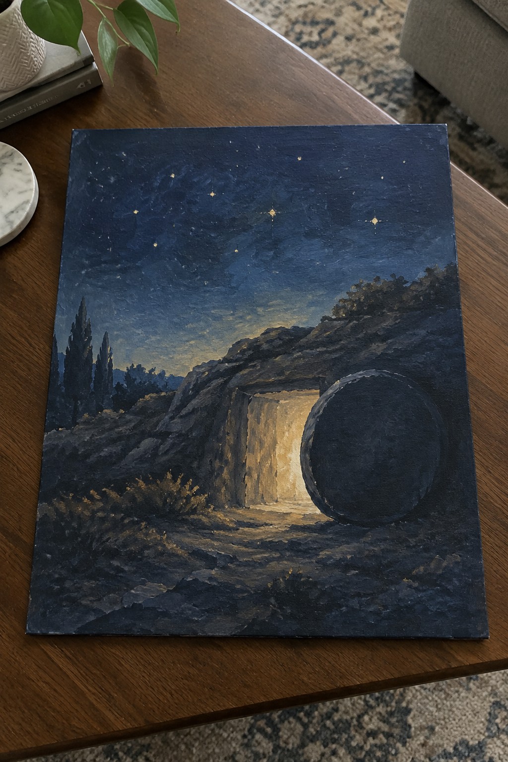 Starry night sky above rocky hillside with glowing open tomb and large rolled stone.